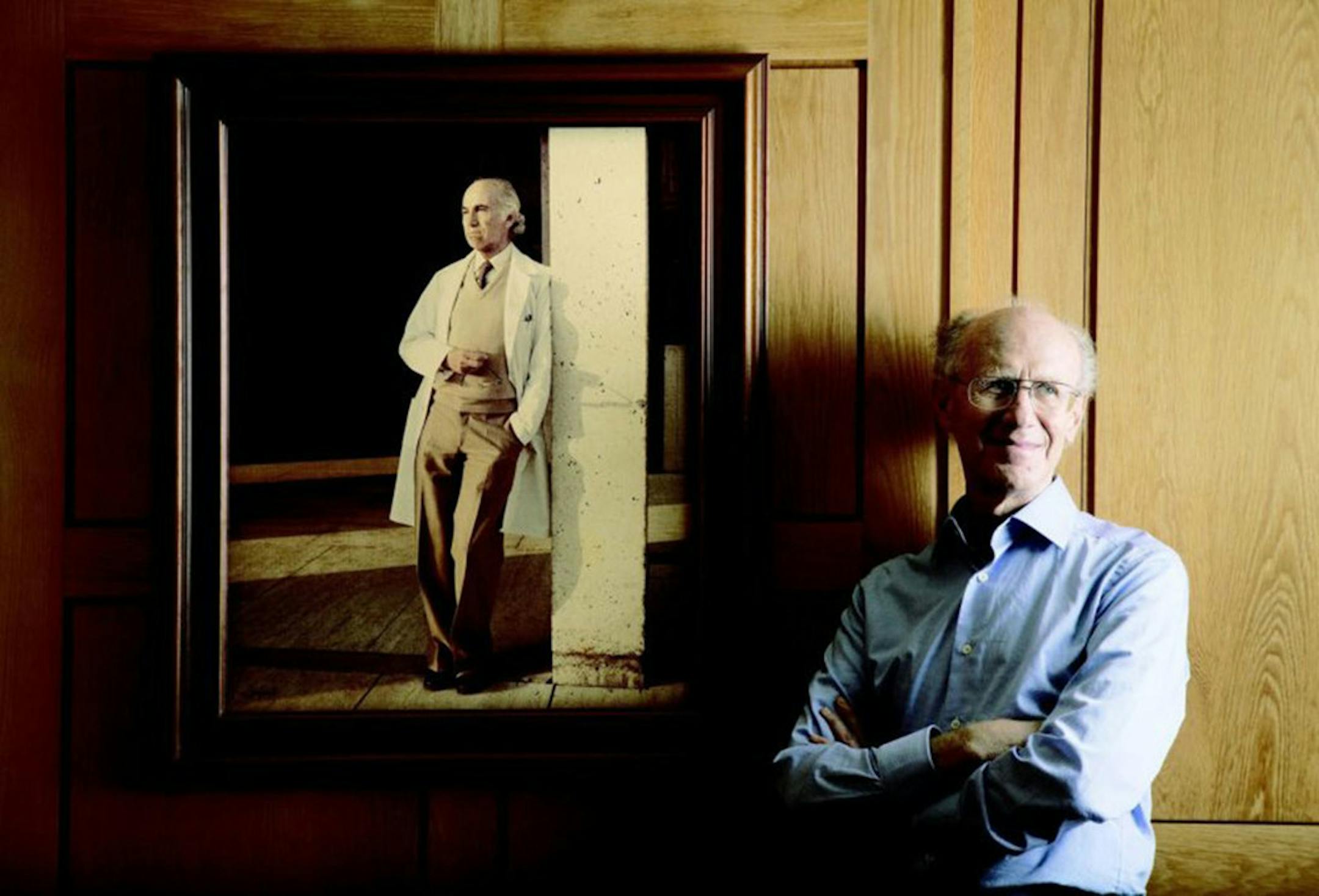 Peter Salk, whose father conquered polio, says coronavirus fight is far from over. He's seen near a photo of his famous father at the Salk Institute for Biological Studies in La Jolla, Calif. The elder Salk discovered and developed the first successful inactivated polio vaccine.
