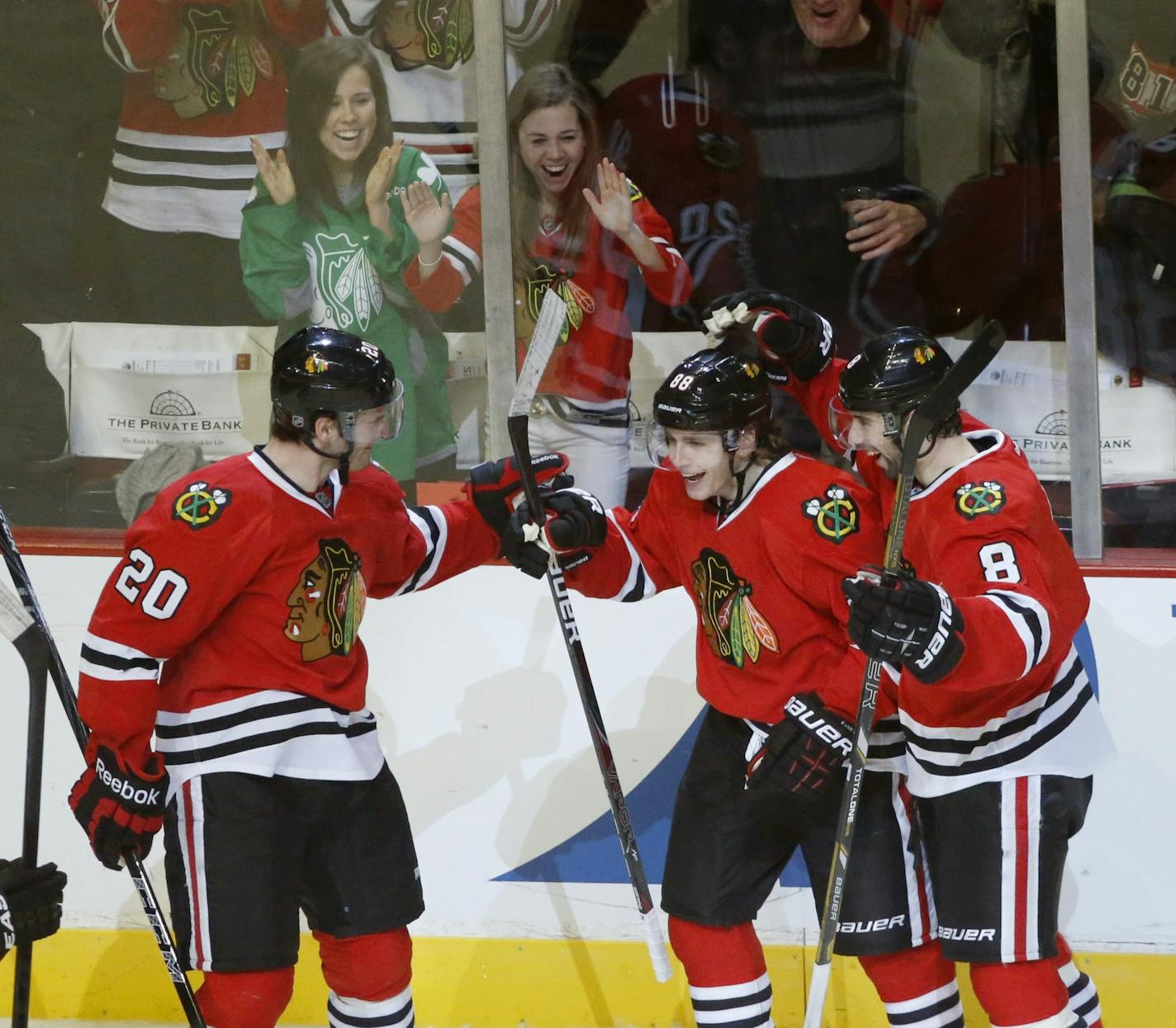 Chicago Blackhawks right wing Patrick Kane (88) celebrates his goal with Brandon Saad (20) and Nick Leddy (8) during the third period of an NHL hockey game against the Edmonton Oilers Sunday, March 10, 2013 in Chicago. The Oilers won 6-5. (AP Photo/Charles Rex Arbogast) ORG XMIT: MIN2013031419120236