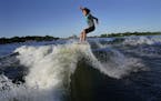 Bethany Anderson, 13, wake boards Friday on Lake Minnetonka in Orono, MN. The Anderson family is among a growing population that participate in the wa