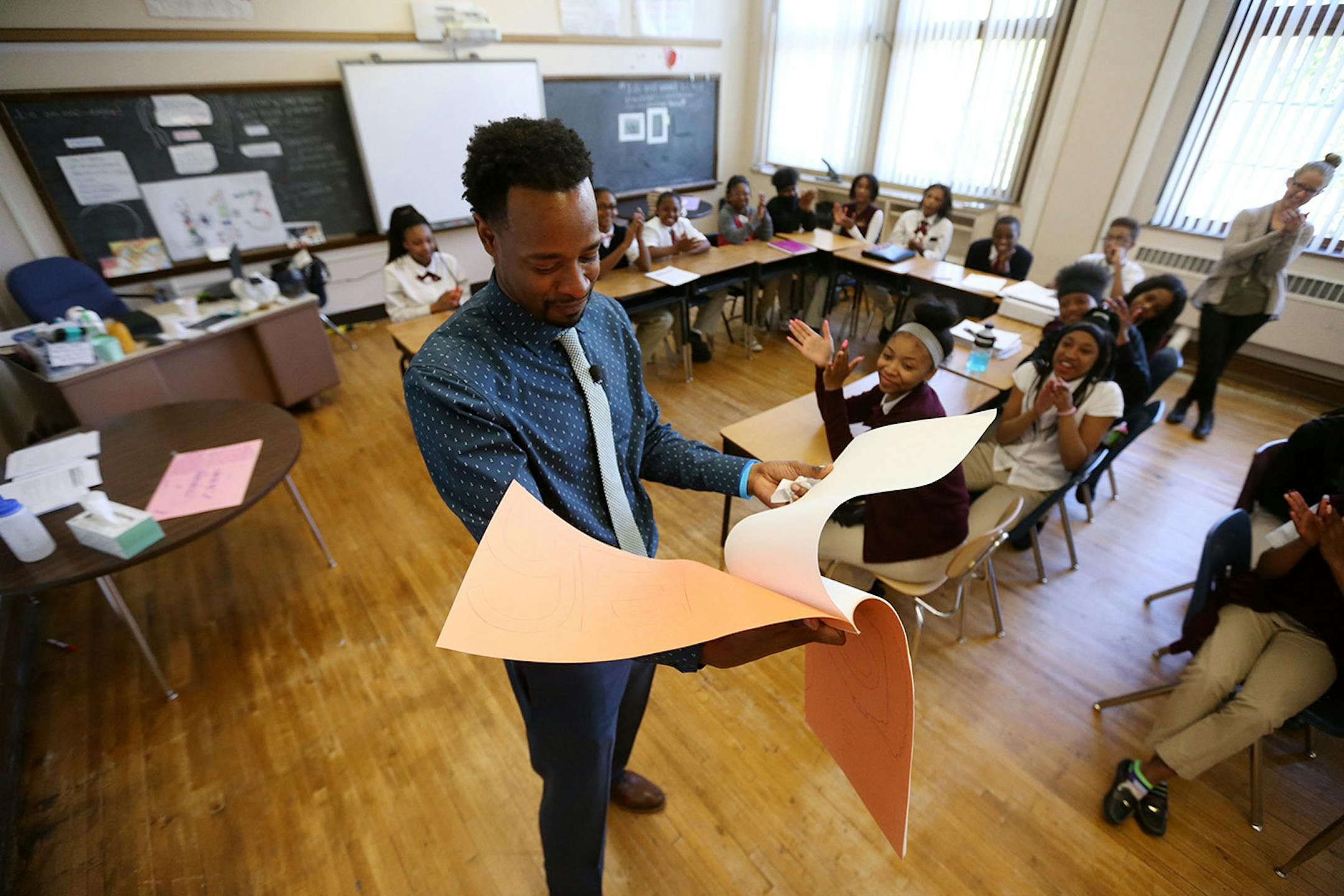Language arts teacher Abdul Wright read a congratulations letter from his students in his classroom at Best Academy Monday after he won the 2016 Minnesota Teacher of the Year award.