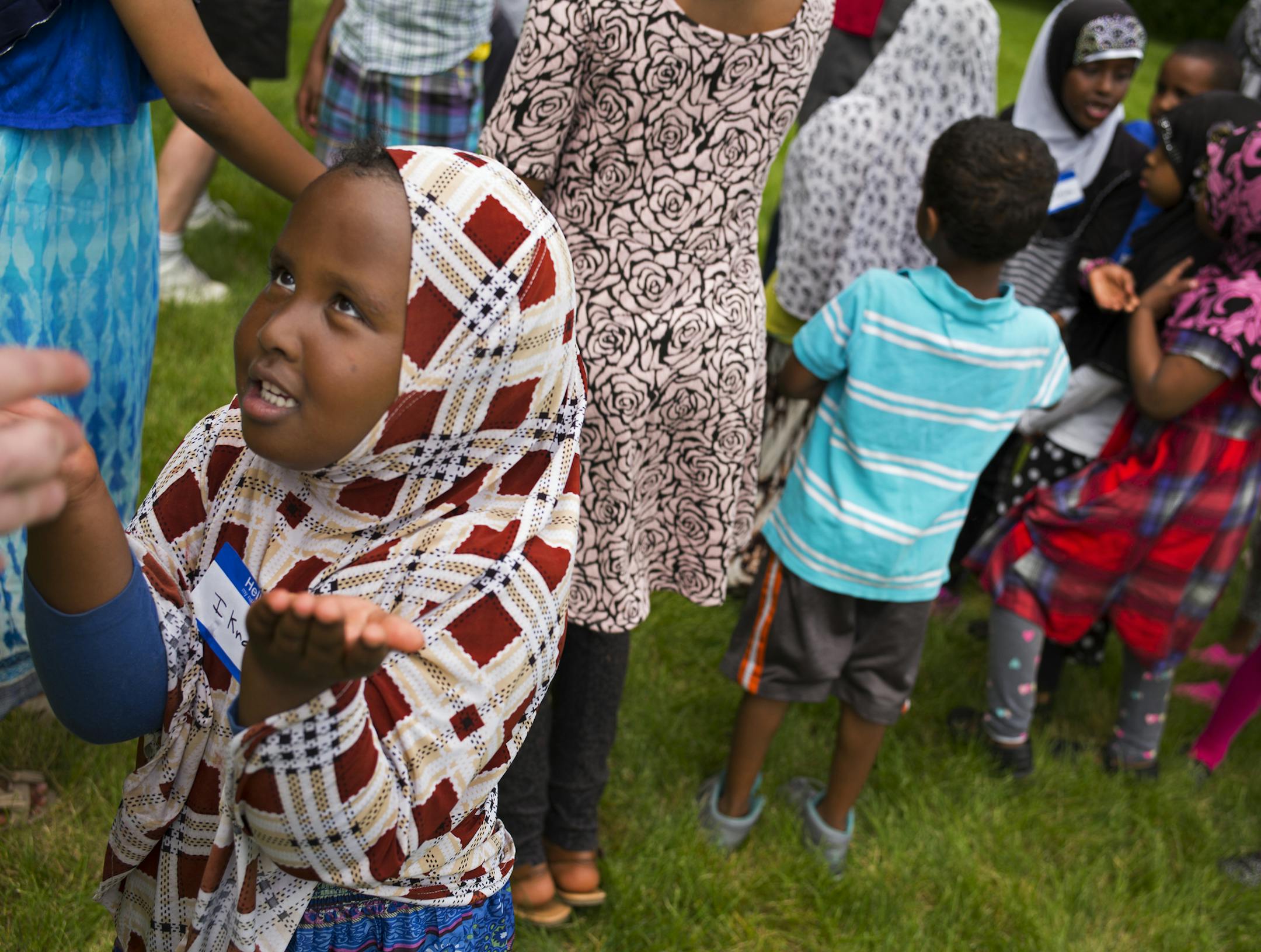 At a park near their apartment complex in Eden Prairie, Ikram Hussein,6, got some instructions on capture the flag before the start of the game. ] Richard Tsong-Taatarii/rtsong-taatarii@startribune.com