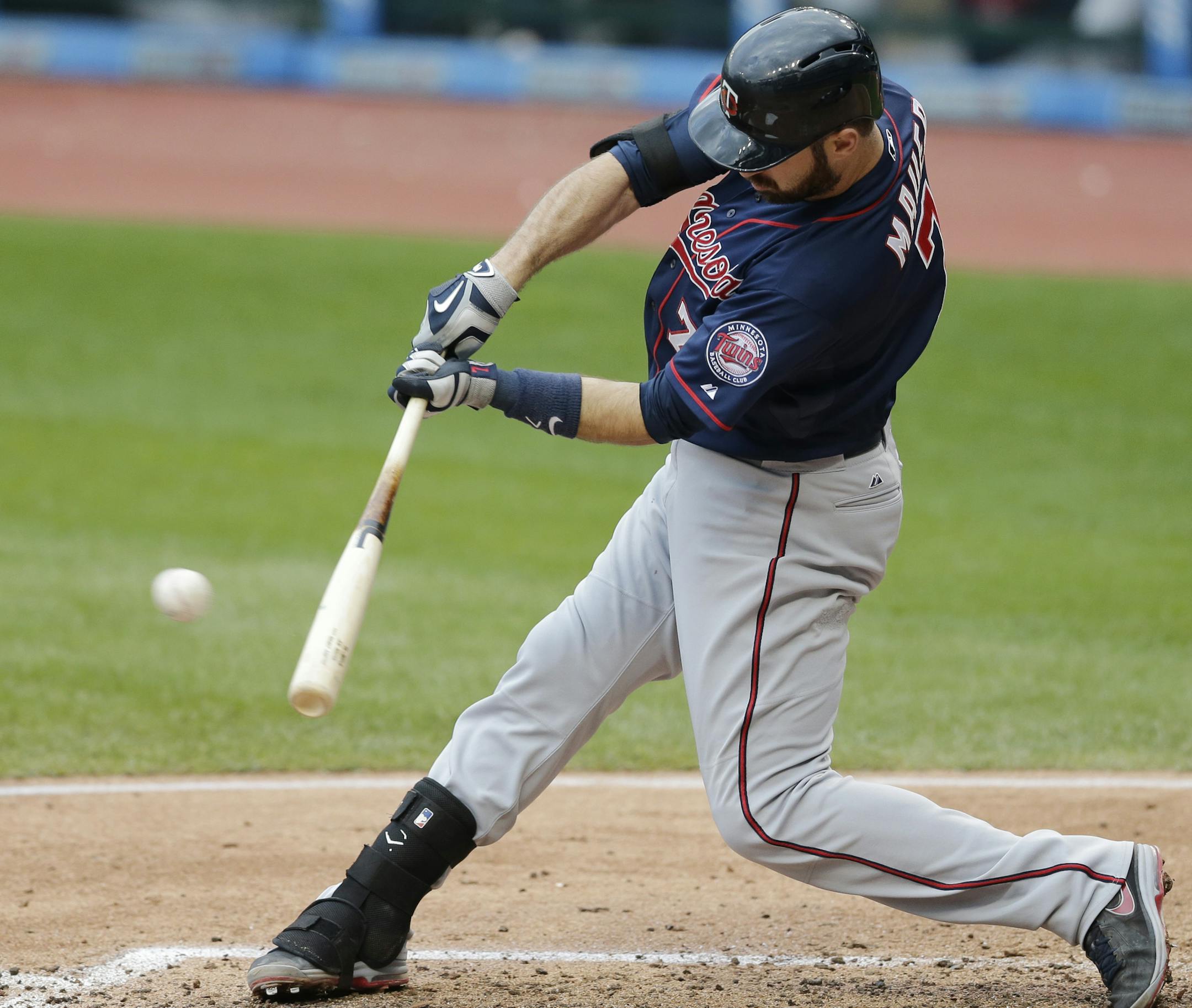 Minnesota Twins' Joe Mauer hits a double off Cleveland Indians starting pitcher Carlos Carrasco in the fourth inning of the first baseball game of a doubleheader, Wednesday, Sept. 30, 2015, in Cleveland. (AP Photo/Tony Dejak)