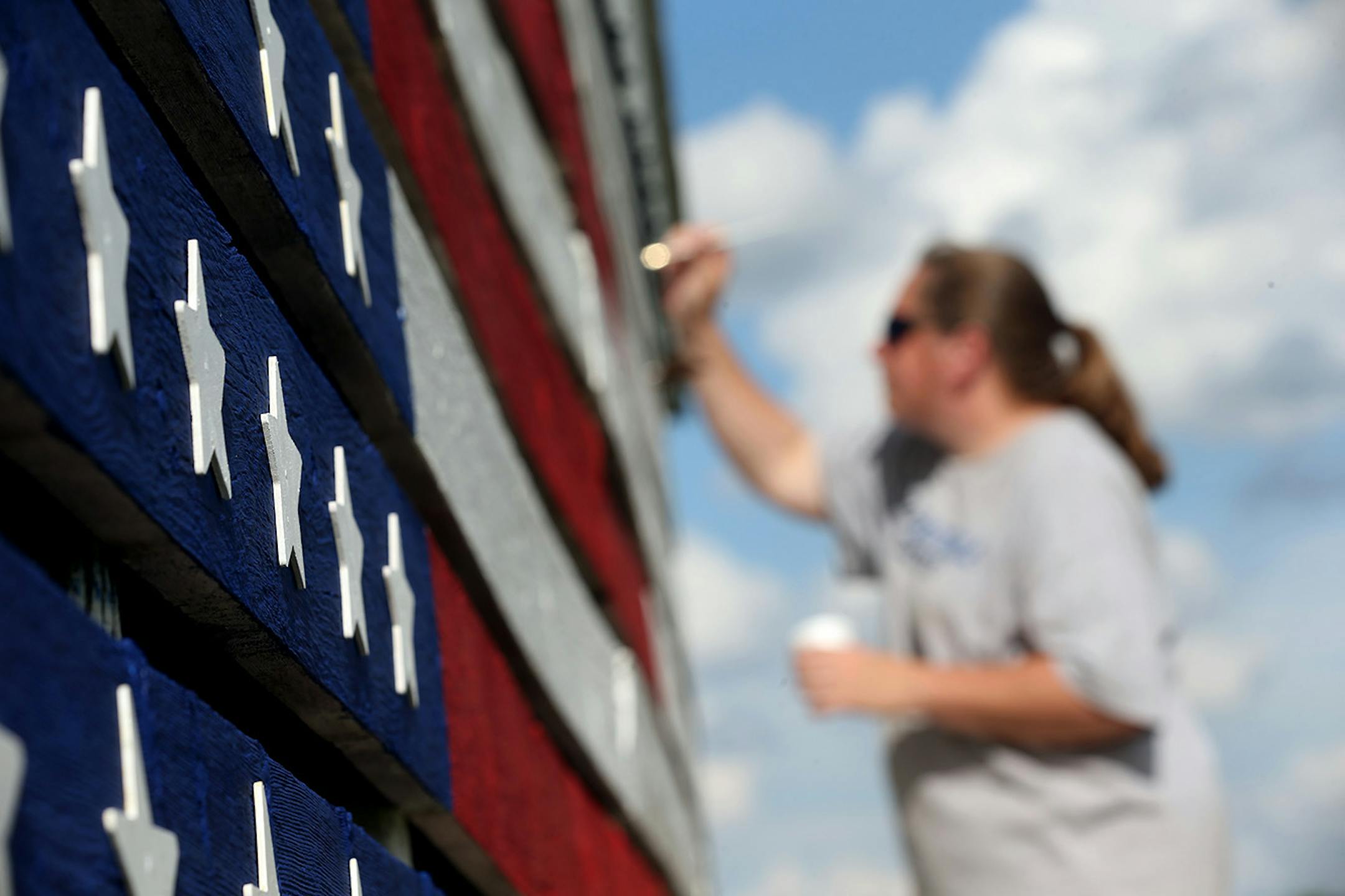 Ann Klindworth painted the names of 15 relatives that have served in the U.S. military on the family barn in their honor for Memorial Day Sunday May 29 2016 in Chatfield, MN.