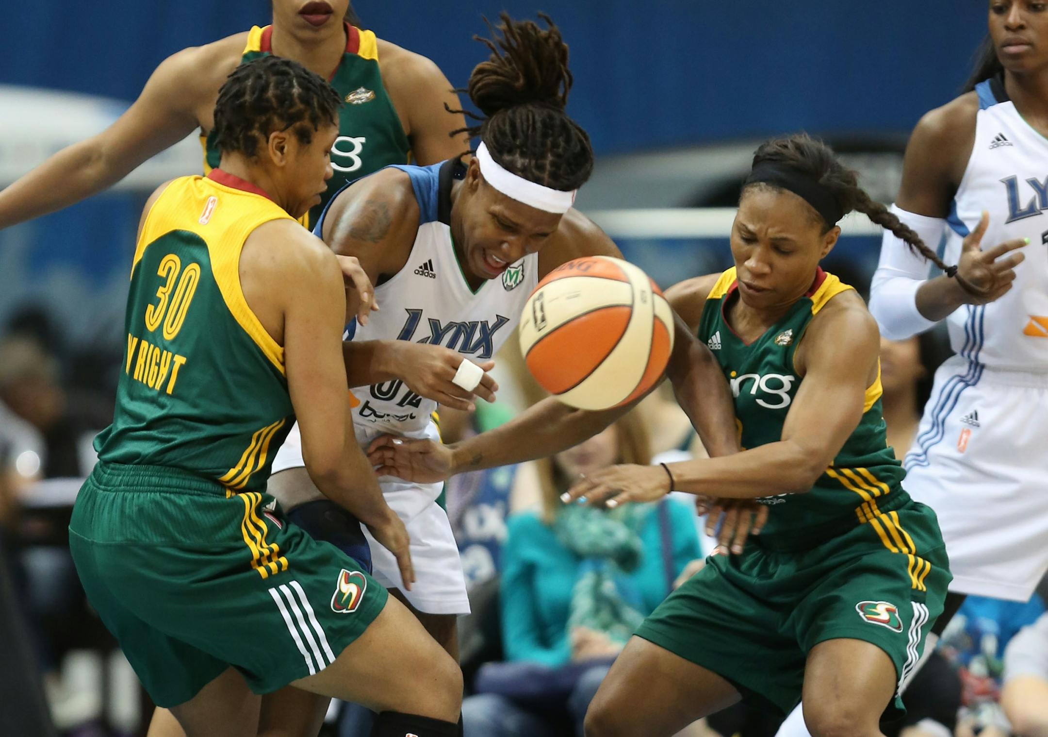 Lynx Rebekkah Brunson tried to fight through the defense of the Storm's Tanisha Wright and Temeka Johnson during the first half of the first round of the playoffs at the Target Center in Minneapolis Friday September 20, 2013.