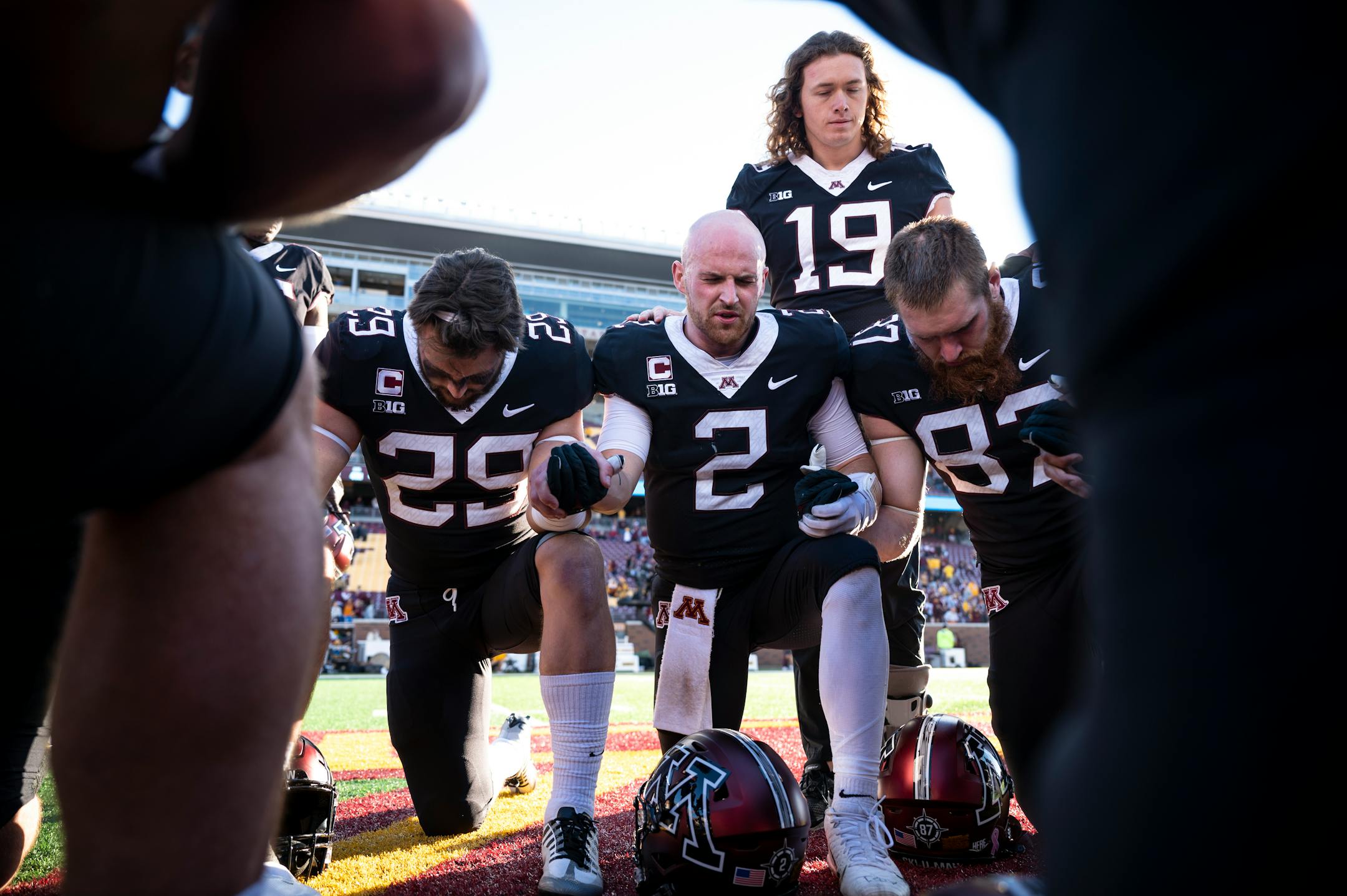 Minnesota Golden Gophers quarterback Tanner Morgan (2) leads his teammates in prayer after their game.
