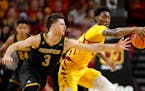 Milwaukee guard Brock Stull, left, fights for a loose ball with Iowa State forward Zoran Talley Jr. in November. Stull will play for the Gophers.