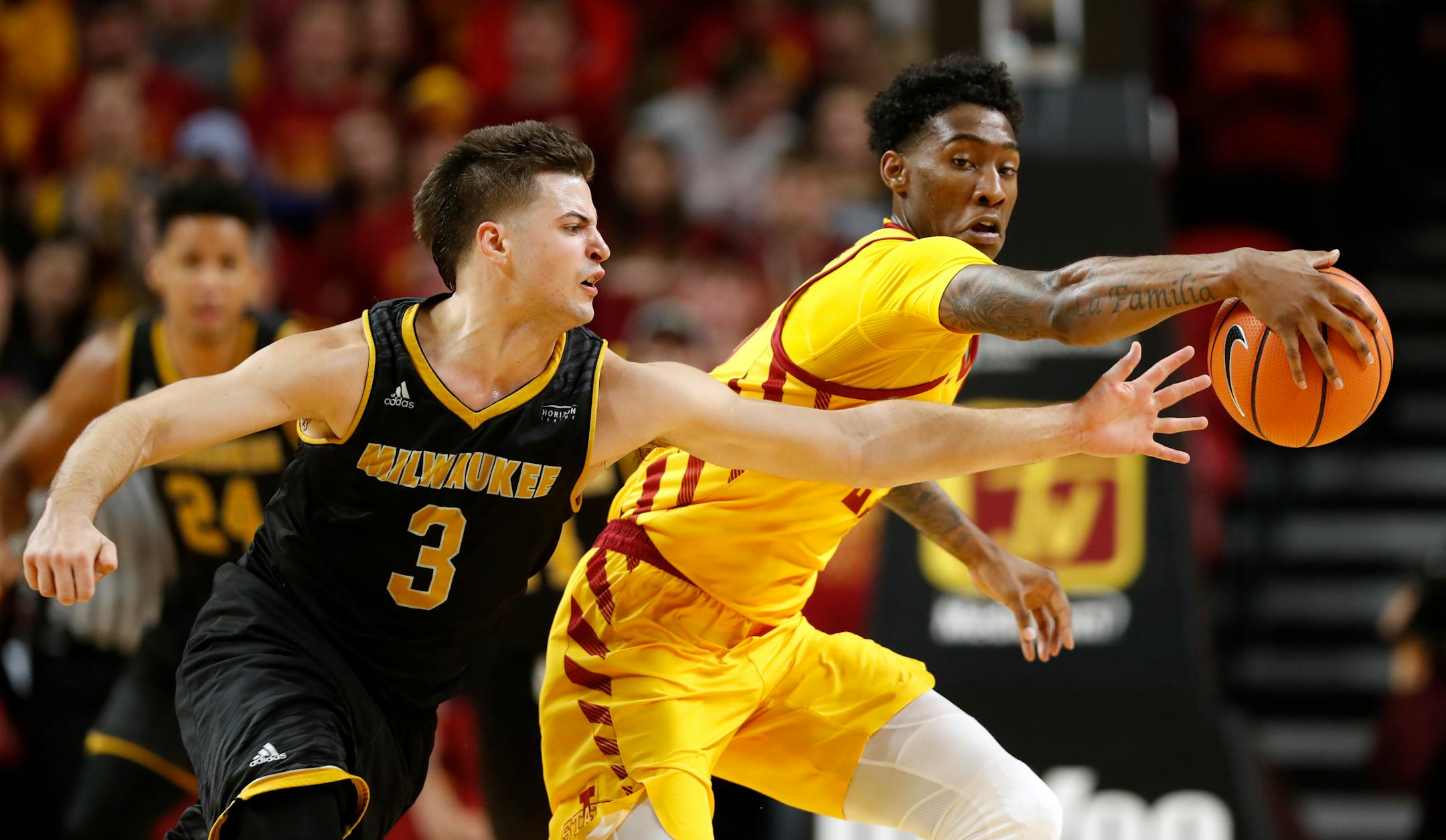 Milwaukee guard Brock Stull, left, fights for a loose ball with Iowa State forward Zoran Talley Jr. in November. Stull will play for the Gophers.