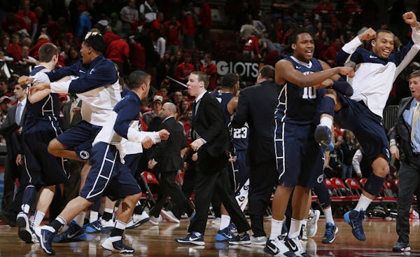 Penn State celebrates a 71-70 overtime victory against Ohio State at Value City Arena in Columbus, Ohio, on Wednesday, Jan. 29, 2014. (Eric Albrecht/C