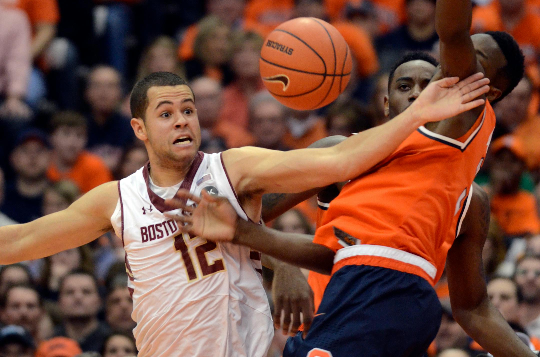 Boston College's Ryan Anderson, left, battles Syracuse's Jerami Grant for a loose ball during the first half of an NCAA college basketball game in Syracuse, N.Y., Wednesday, Feb. 19, 2014. (AP Photo/Kevin Rivoli)