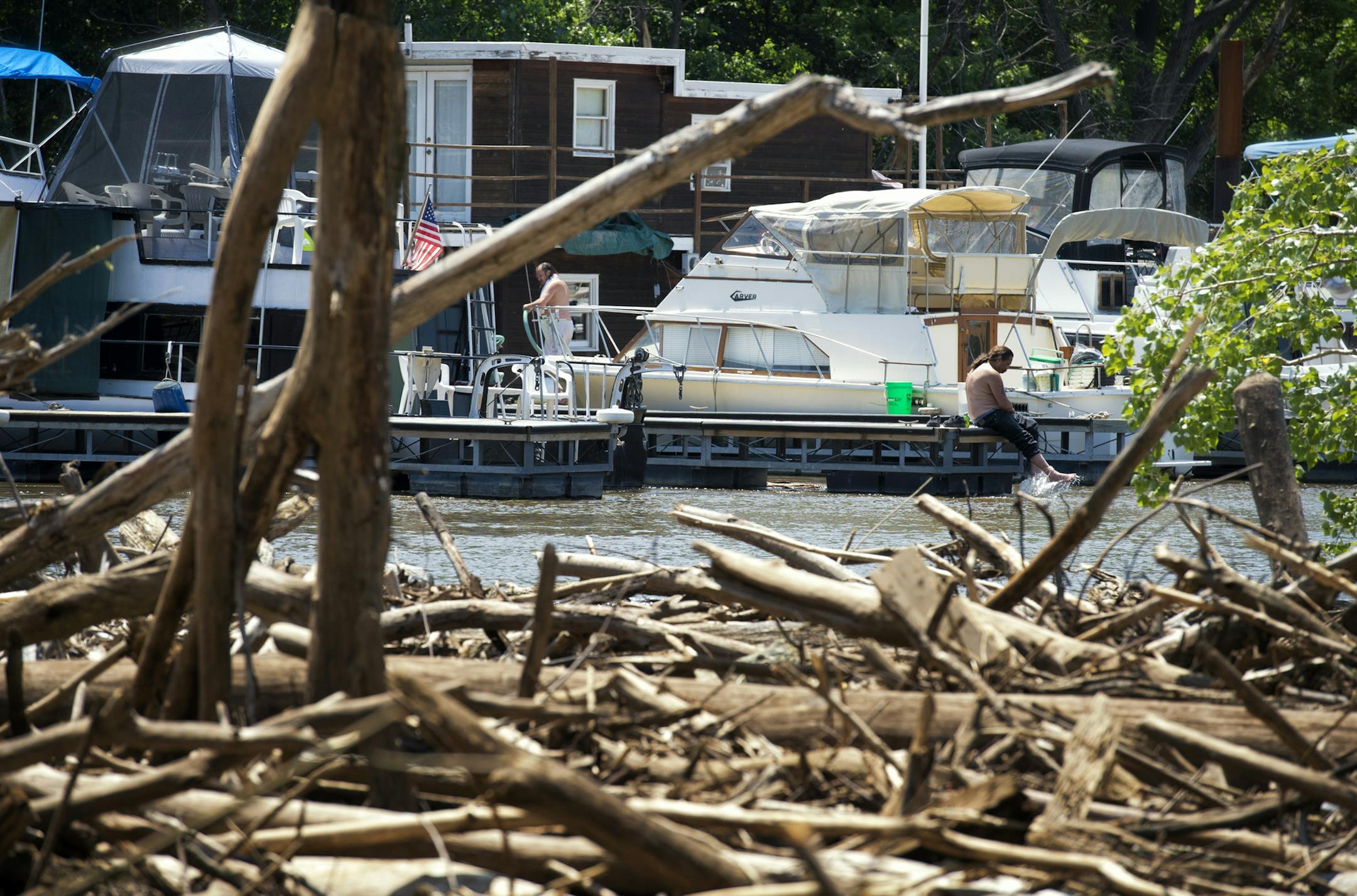 A huge logjam of trees downed by recent high winds and rising flood waters has piled up under the Wabasha Bridge, blocking boats into their slips at the St. Paul Yacht Club and creating a navigational hazard, Tuesday, July 2, 2013 ] GLEN STUBBE * gstubbe@startribune.com