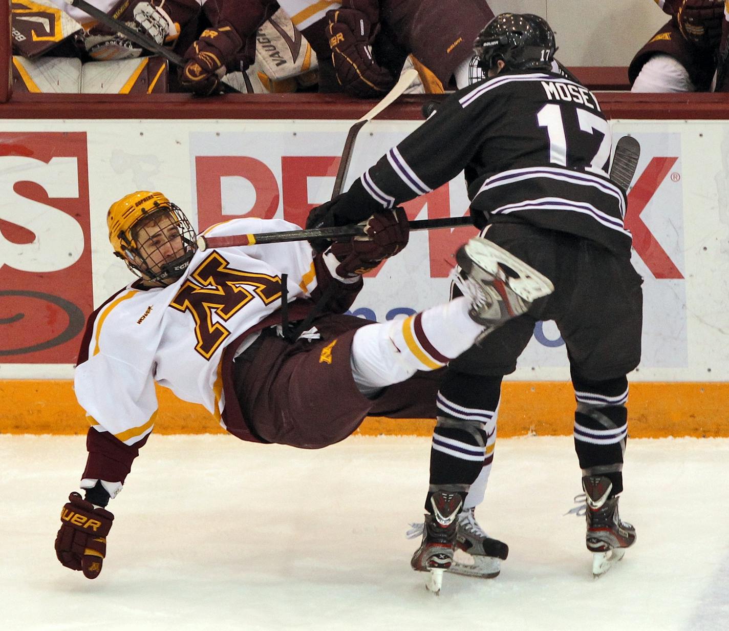 Evan Mosey (17) sent the Gophers Jake Parenteau to the ice with a first period check.