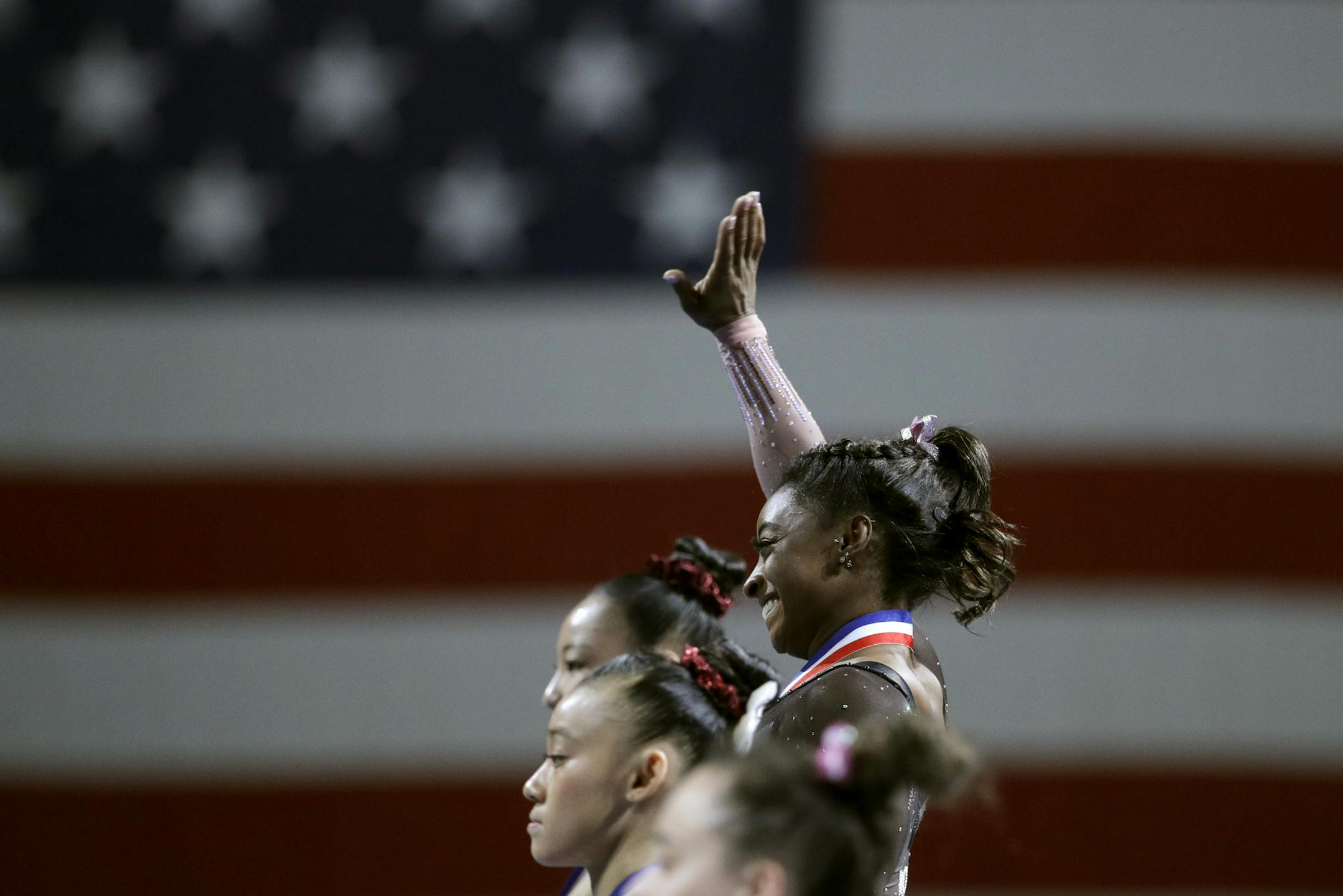 Simone Biles stands on the podium with other winners of the floor exercise after the senior women's competition at the 2019 U.S. Gymnastics Championships Sunday, Aug. 11, 2019, in Kansas City, Mo. (AP Photo/Charlie Riedel)