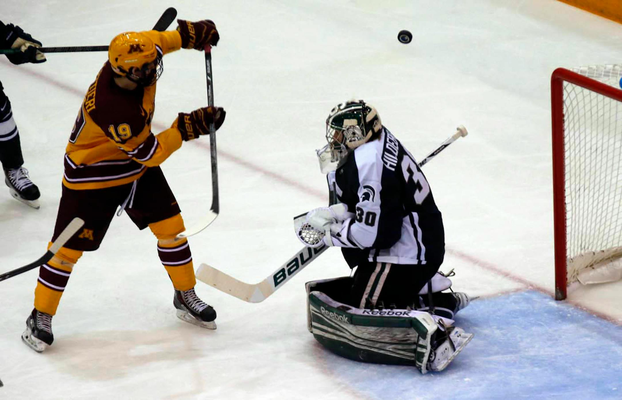 Minnesota Gophers vs. Michigan State hockey. Minnesota's Vinni Lettieri (19) just missed on this shot on goal against Spartan goalie Jake Hildebrand. (MARLIN LEVISON/STARTRIBUNE(mlevison@startribune.com)