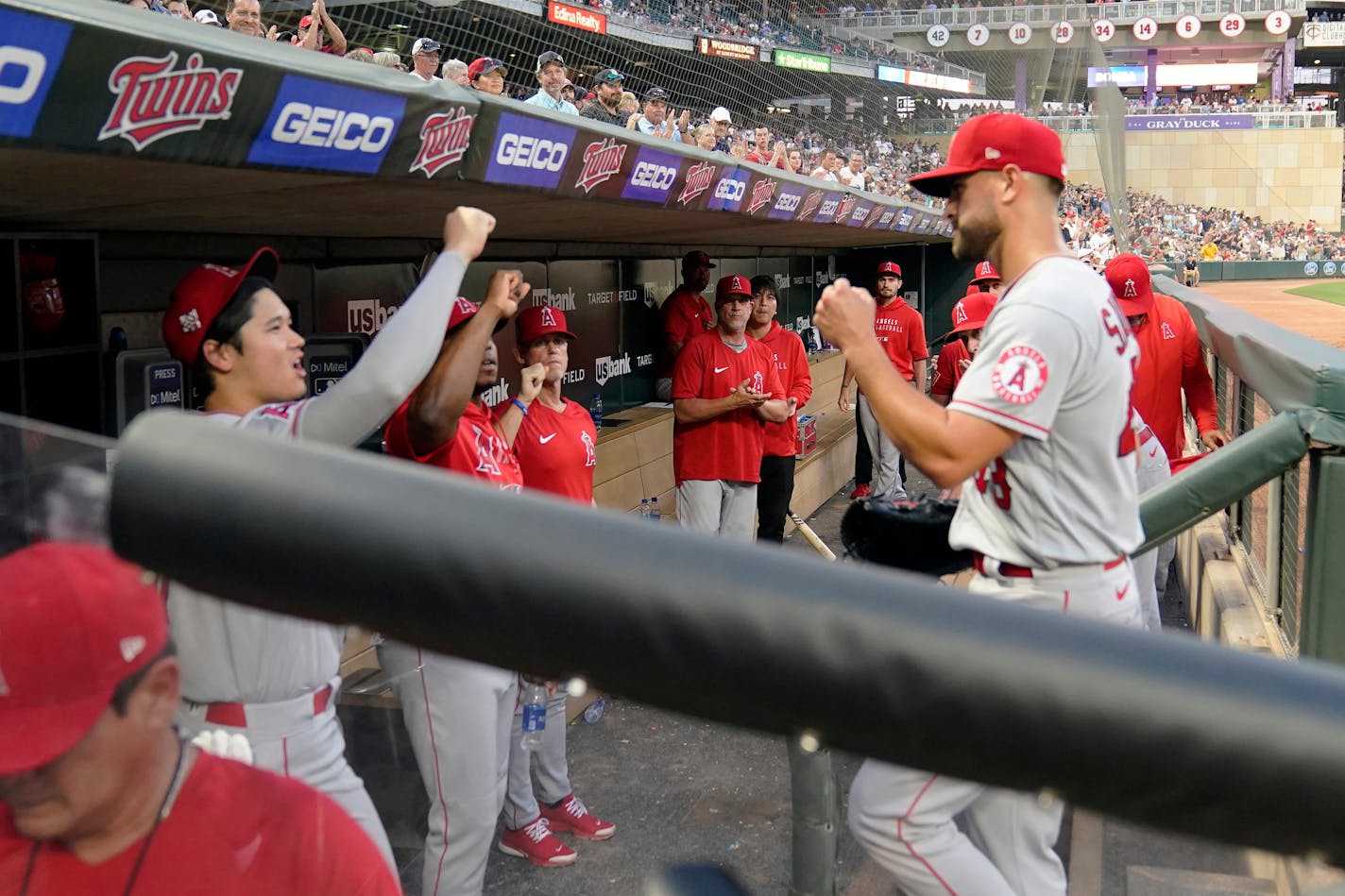 Los Angeles Angels' pitcher Patrick Sandoval, right, is greeted by Shohei Ohtani, left, after leaving a baseball game against the Minnesota Twins, Saturday, July 24, 2021, in Minneapolis. Sandoval had a no-hitter going into the night but gave up a double to Twins' Brent Rooker. (AP Photo/Jim Mone)