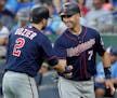 Minnesota Twins' Brian Dozier congratulates teammate Joe Mauer after Mauer scored on a single by Eddie Rosario in July. Mauer retired on Friday.