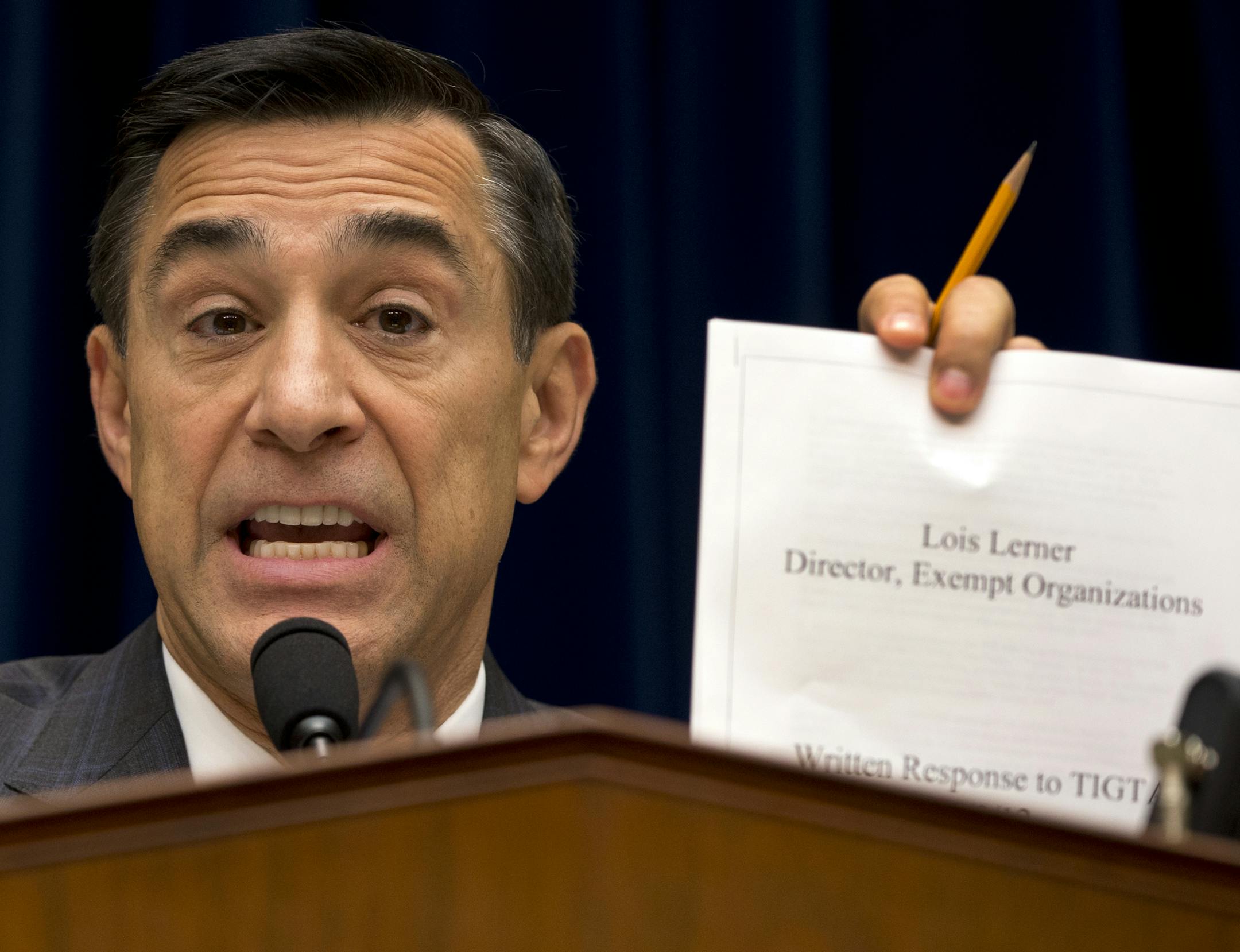 House Oversight Committee Chairman Rep. Darrell Issa, R-Calif. holds up a document as he speaks to IRS official Lois Lerner on Capitol Hill in Washington, Wednesday, May 22, 2013, during the committee's hearing to investigate the extra scrutiny IRS gave to Tea Party and other conservative groups that applied for tax-exempt status. Lerner told the committee she did nothing wrong and then invoked her constitutional right to not answer lawmakers' questions. (AP Photo/Carolyn Kaster)