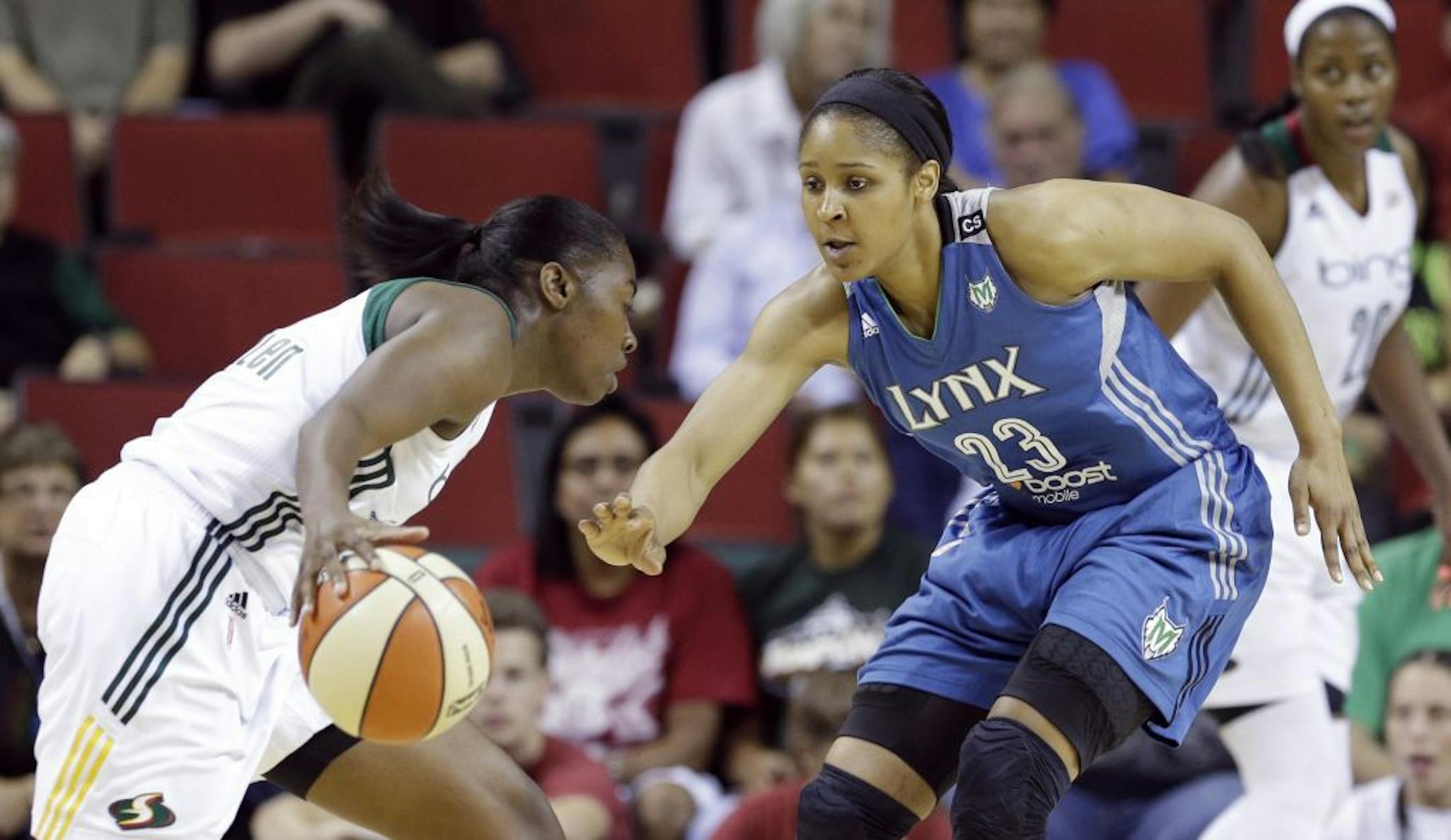 Minnesota Lynx's Maya Moore (23) defends Seattle Storm's Shekinna Stricklen in the first half of a WNBA basketball game Tuesday, Sept. 10, 2013, in Seattle.