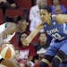 Minnesota Lynx's Maya Moore (23) defends Seattle Storm's Shekinna Stricklen in the first half of a WNBA basketball game Tuesday, Sept. 10, 2013, in Se