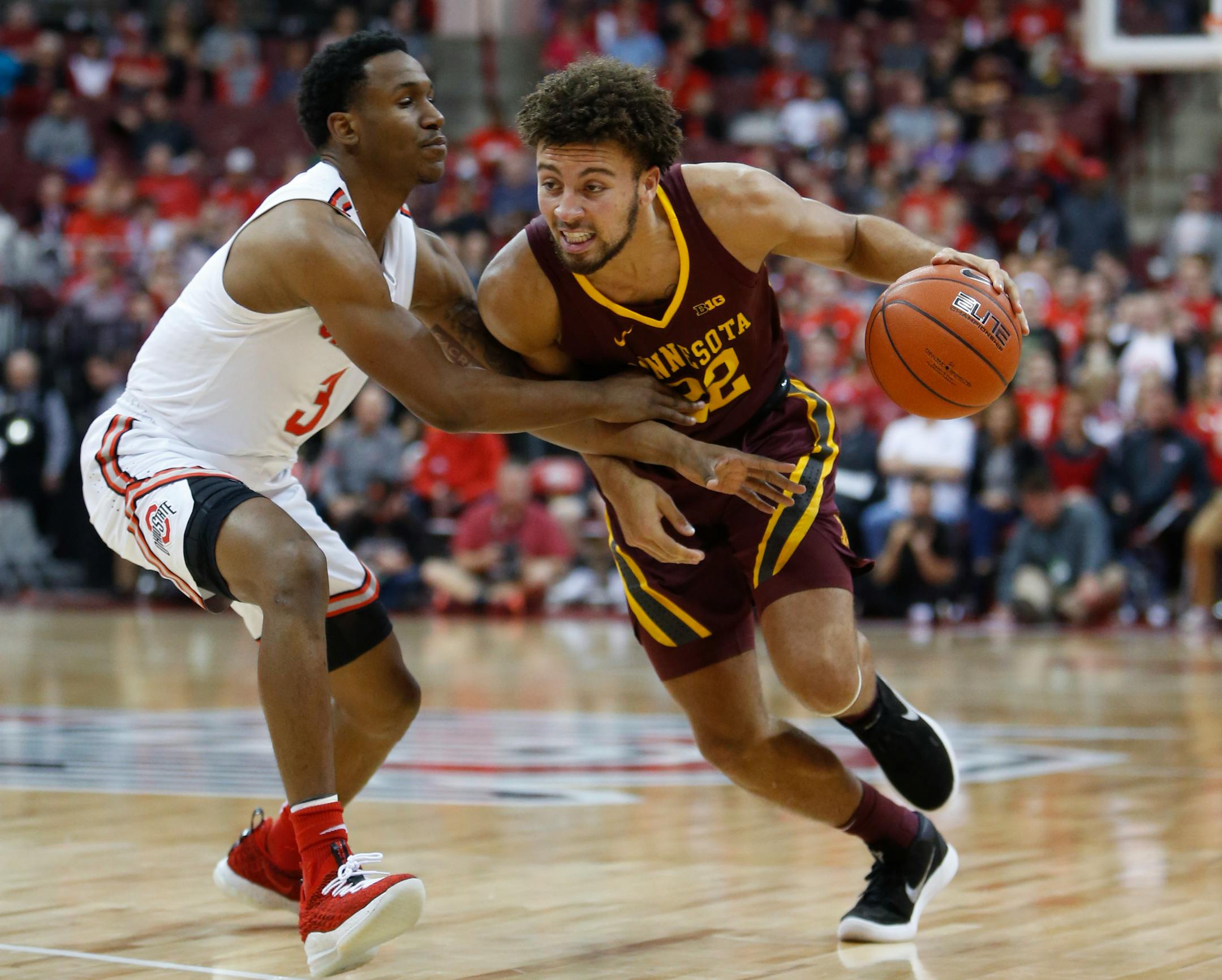 Minnesota's Gabe Kalscheur, right, drives to the basket against Ohio State's C.J. Jackson during the first half of an NCAA college basketball game Sunday, Dec. 2, 2018, in Columbus, Ohio. (AP Photo/Jay LaPrete)