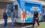 HCMC staff visit Hennepin Healthcare's mobile pediatric van outside the hospital in 2022.