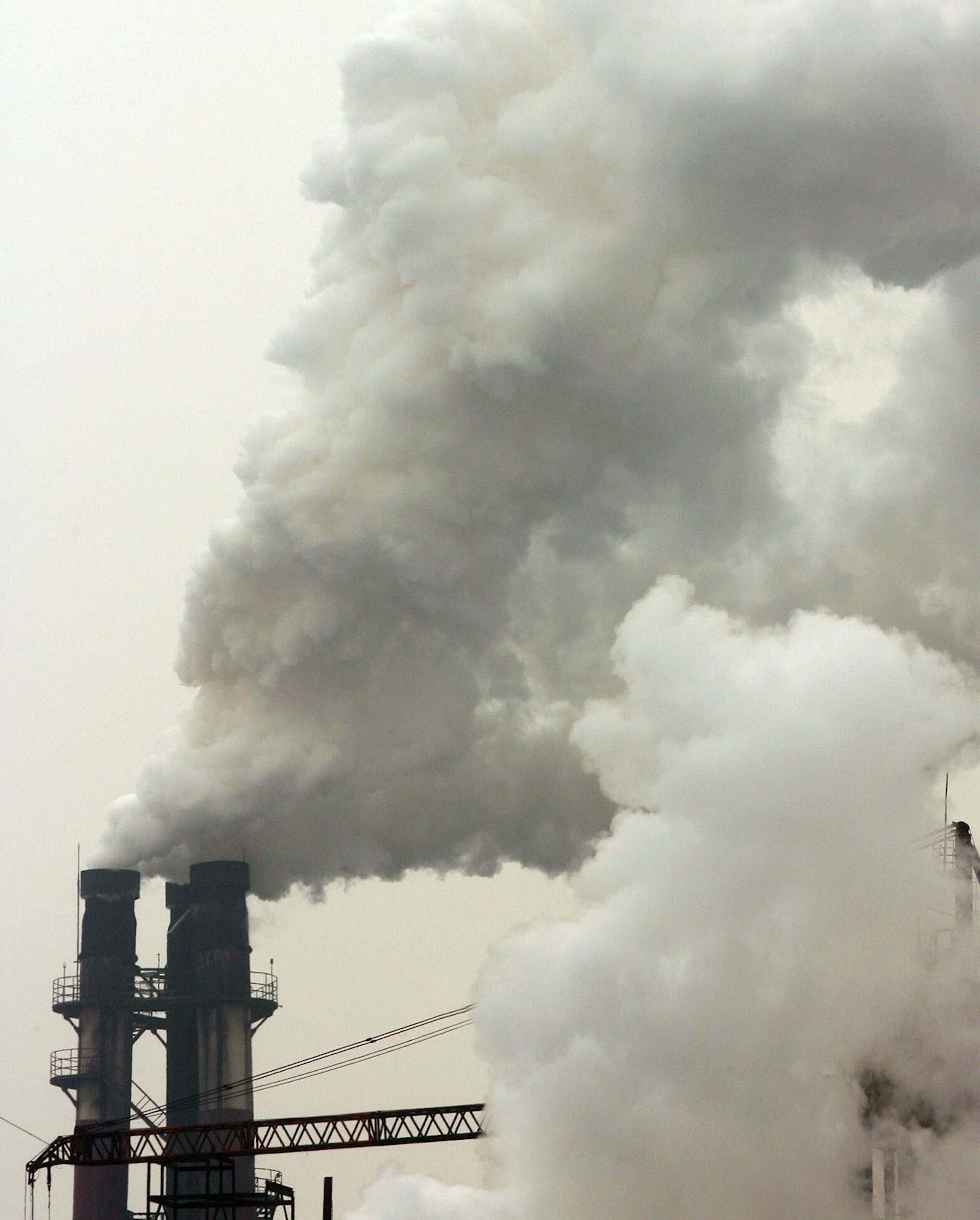 Smoke comes out of the chimneys of Beijing Shougang Co Ltd steel plant in Beijing, China, on January 11, 2006. Robin Howlett says Beijing was a city of blue skies and open roads when he arrived from the U.K. in 1988. These days, he rides his scooter wearing a surgical mask to keep out dust and fumes from the Chinese capital's 8,000 construction sites and more than 2 million vehicles. "It's bad, but this is my home," said Howlett, 38, a bar and restaurant owner. Pollution and traffic congestion a
