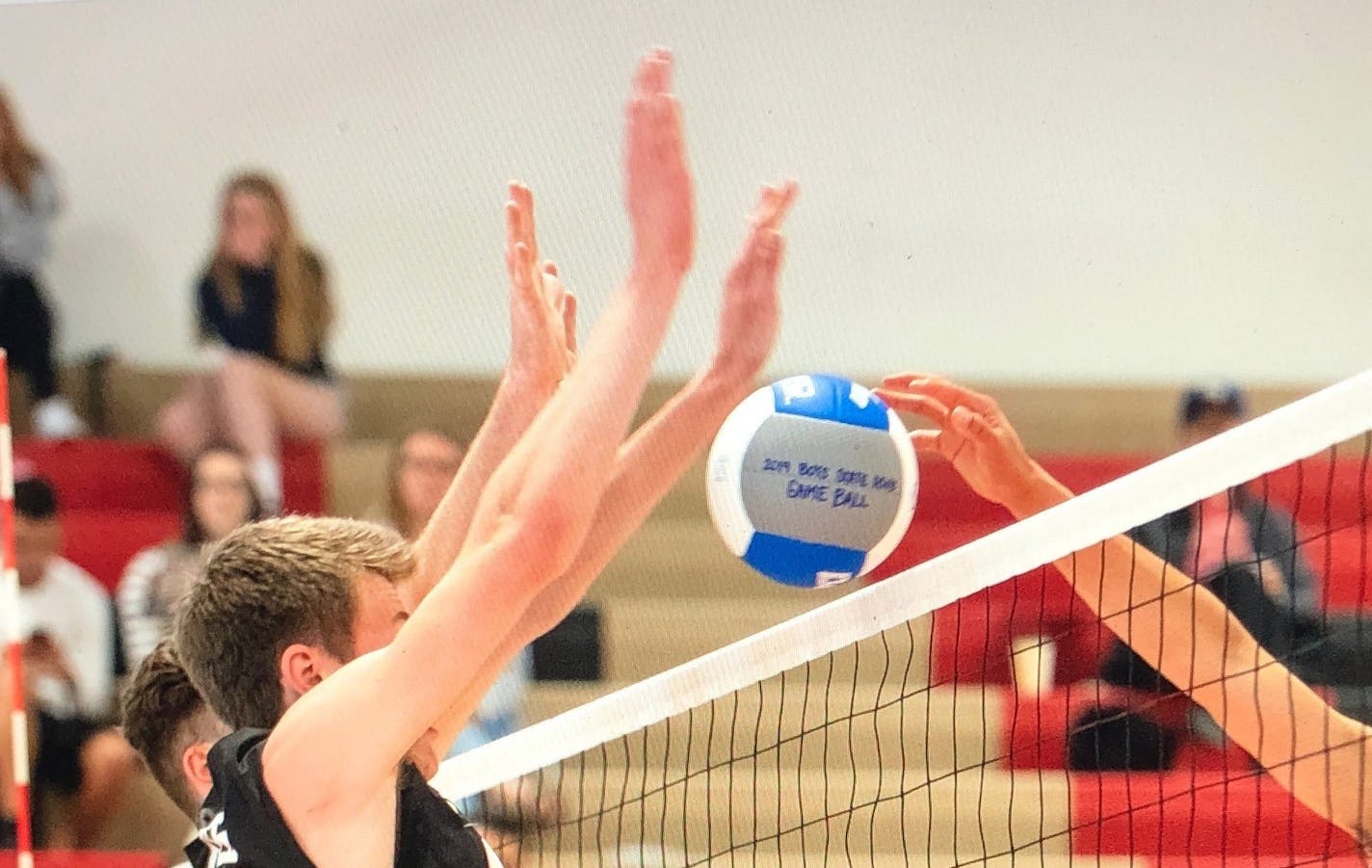 Andover's Derek Owens blocks a kill attempt by St. Paul Harding's Newjai Chang during Sunday's boys' volleyball state championshp match. Andover won 25-13, 19-25, 25-7, 25-23