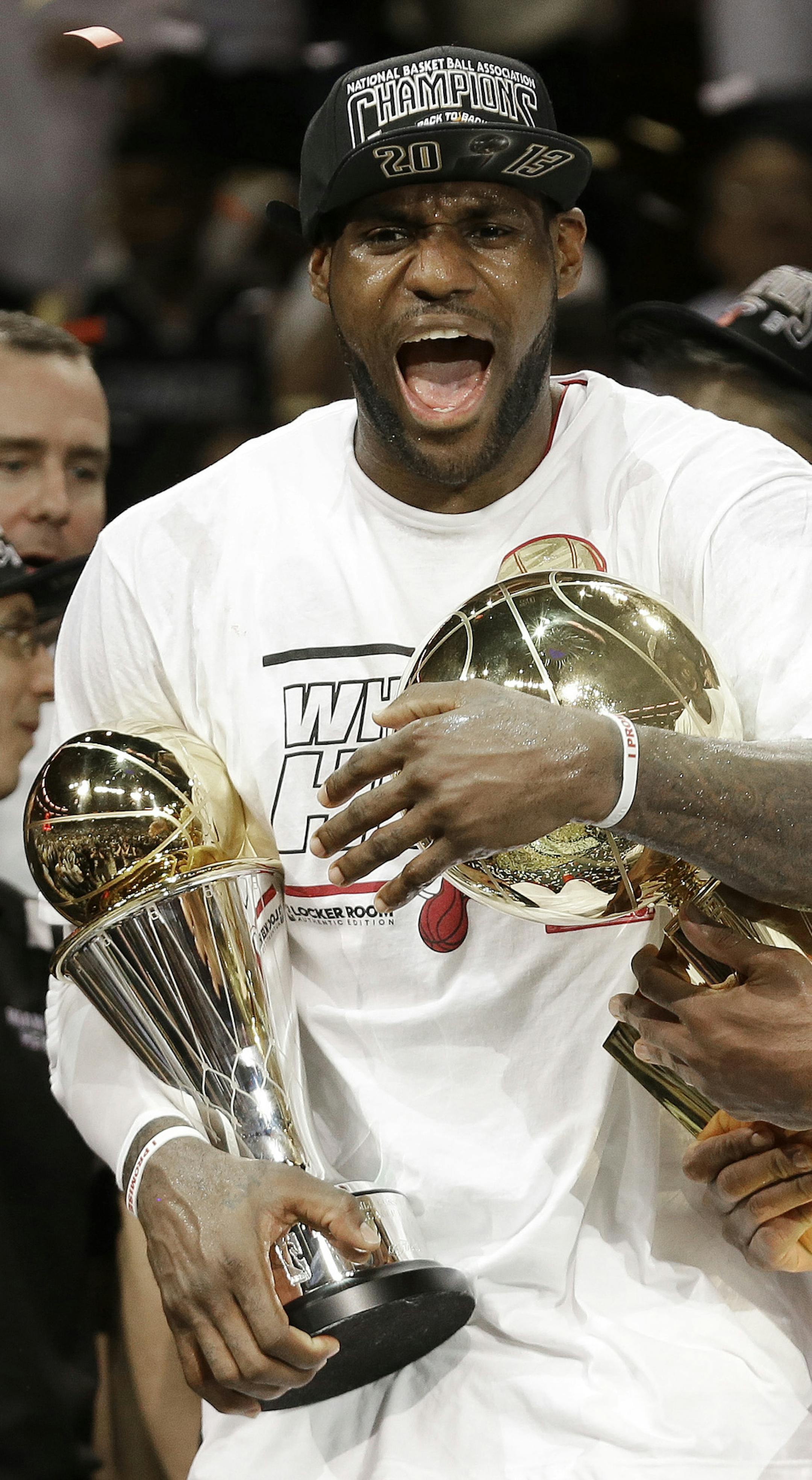 The Miami Heat's Dwyane Wade, right, holds the Larry O'Brien NBA Championship Trophy as LeBron James holds his Bill Russell NBA Finals Most Valuable Player Award after Game 7 of the NBA basketball championship game against the San Antonio Spurs, Friday, June 21, 2013, in Miami. The Miami Heat defeated the San Antonio Spurs 95-88 to win their second straight NBA championship. (AP Photo/Lynne Sladky) ORG XMIT: AAA308