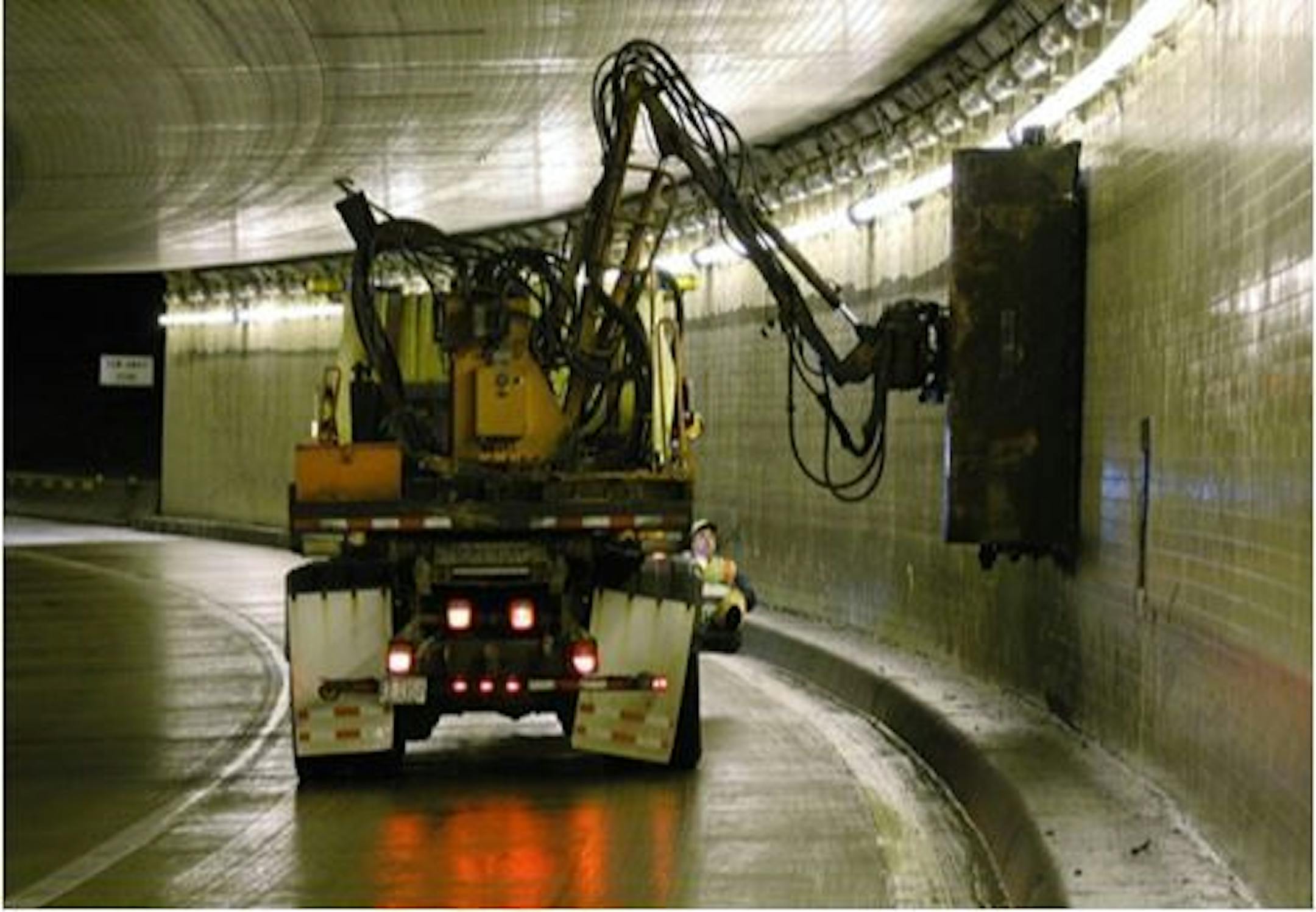 A MnDOT truck washes the inside of the Lowry Hill Tunnel