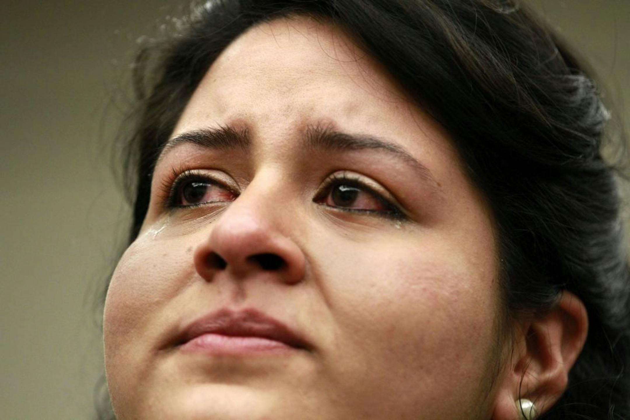 Gaby Pacheco, 27, of Miami, an illegal immigrant originally from Ecuador, cries while watching President Obama announce that the U.S. government will stop deporting and begin granting work permits to younger illegal immigrants who came to the U.S. as children and have since led law-abiding lives, Friday, June 15, 2012, in Washington.