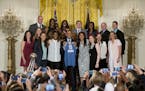 President Barack Obama, center, holds up a team jersey for a group photo in the East Room of the White House in Washington, Monday, June 27, 2016, dur