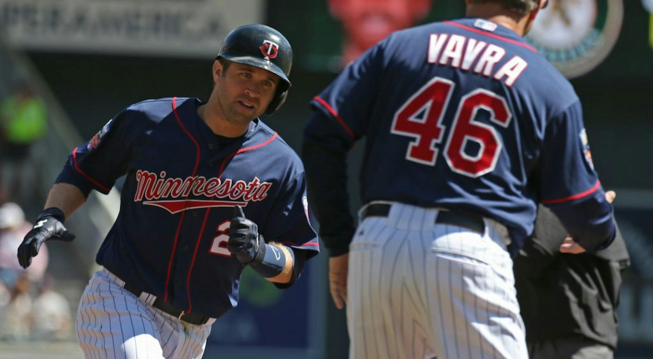 (left) Minnesota Twins Brian Dozier rounded the bases after hitting a first inning home run.