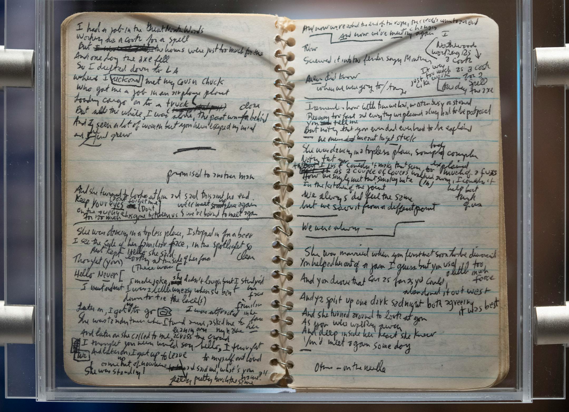 A spread from one of three small, spiral bound notebooks that Bob Dylan used in 1974 to draft lyrics for the album Blood on the Tracks are part of a display about the creation of the seminal album at the Bob Dylan Center in Tulsa, Okla. on Monday, May 9, 2022.
