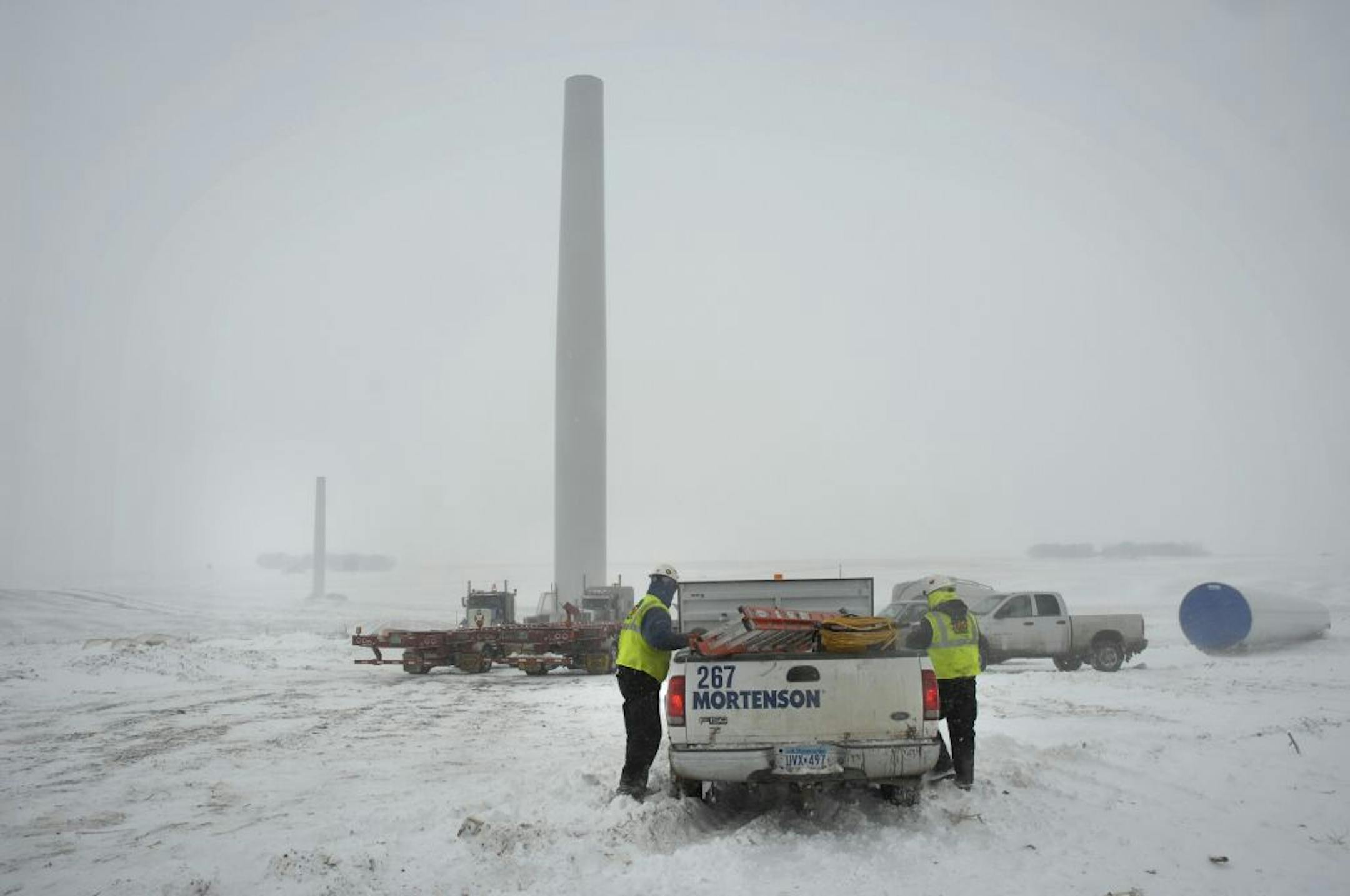 GLEN STUBBE �� gstubbe@startribune.com Wednesday, February 28, 2007 -- Chandler, Minn. -- During a recent snow and sleet storm with 40 mile per hour winds a crew from contractor M. A. Mortenson Co. packed up early after struggling to secure a recently delivered 122 foot wind turbine blades at the 137-turbine Fenton Wind Power Project just south of Chandler in the southwest corner of Minnesota. In the background some of the partially constructed wind towers are visible. Each of the three 122-foot