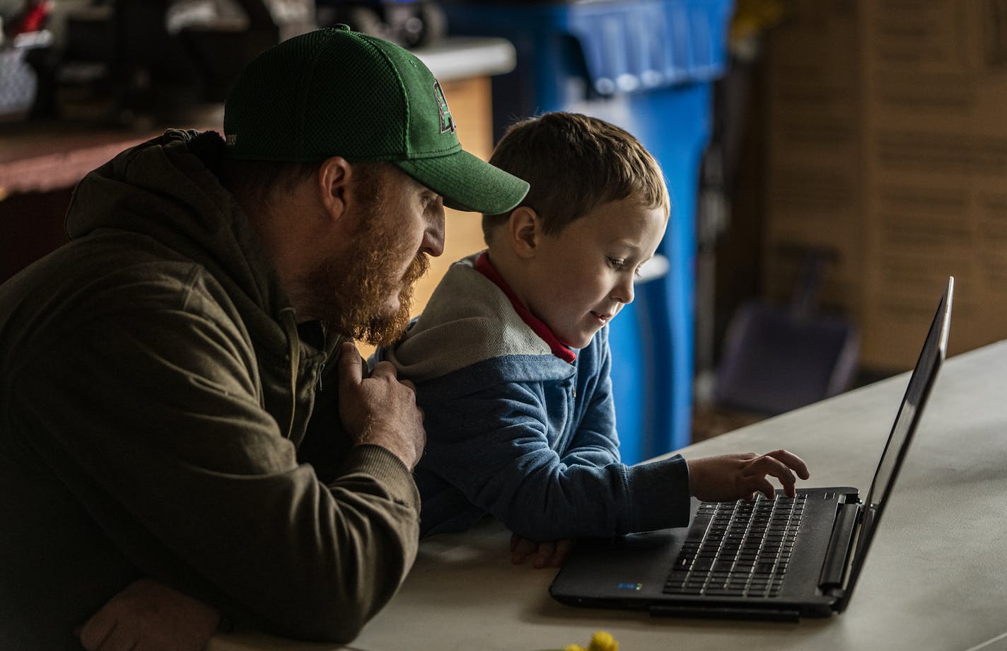 Dan Clapero works with son Franklin(6) on math addition while Calvin(9) reads. Mom is deployed in Kuwait. Her stay has been extended because of Covid-19.] RICHARD TSONG-TAATARII &#xa5; richard.tsong-taatarii@startribune.com