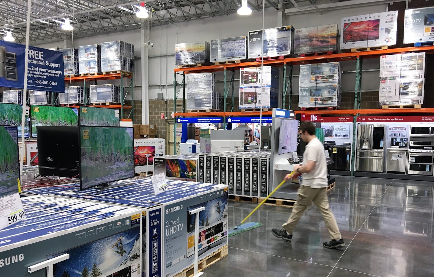 A Costco employee cleans the company's newest store in the Twin Cities, which is opening on Wednesday in Woodbury.