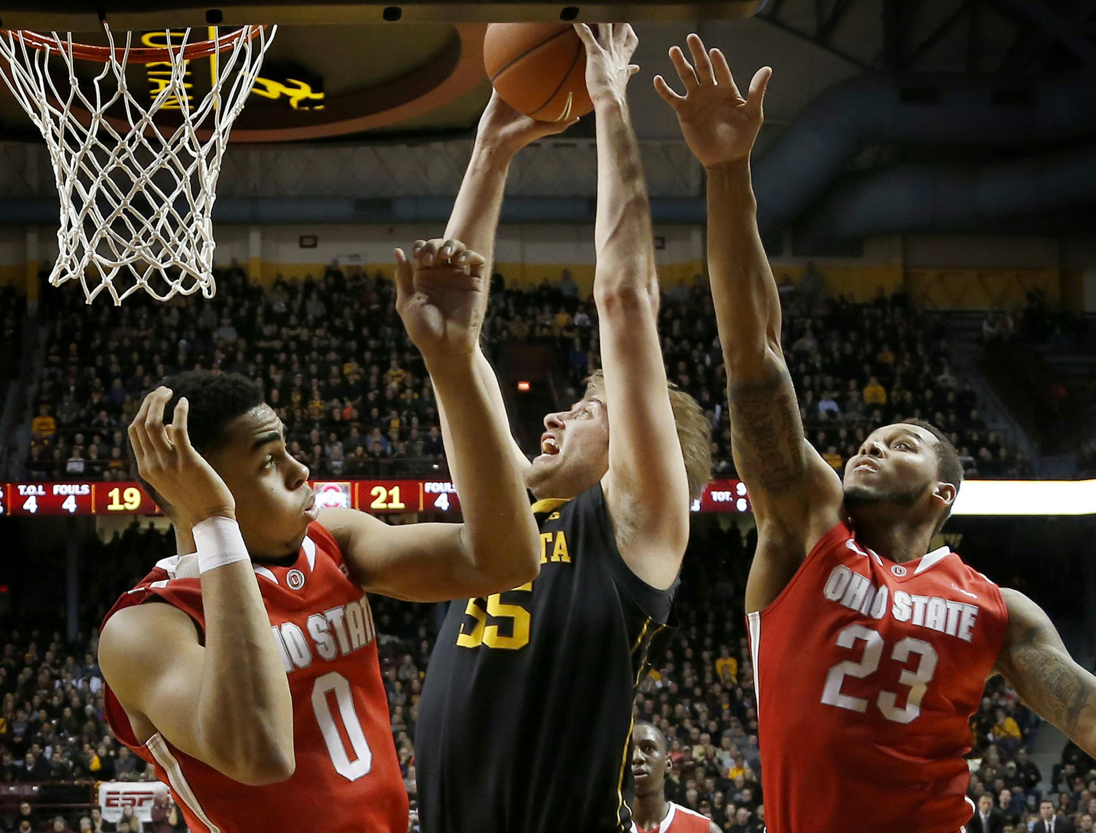 Elliott Eliason (55) attempted a shot while being defended by D'Angelo Russell (0) and Amir Williams (23) in the first half. ] CARLOS GONZALEZ cgonzalez@startribune.com, January 6, 2015, Minneapolis, Minn., Williams Arena, NCAA Basketball, University of Minnesota Gophers vs. Ohio State Buckeyes
