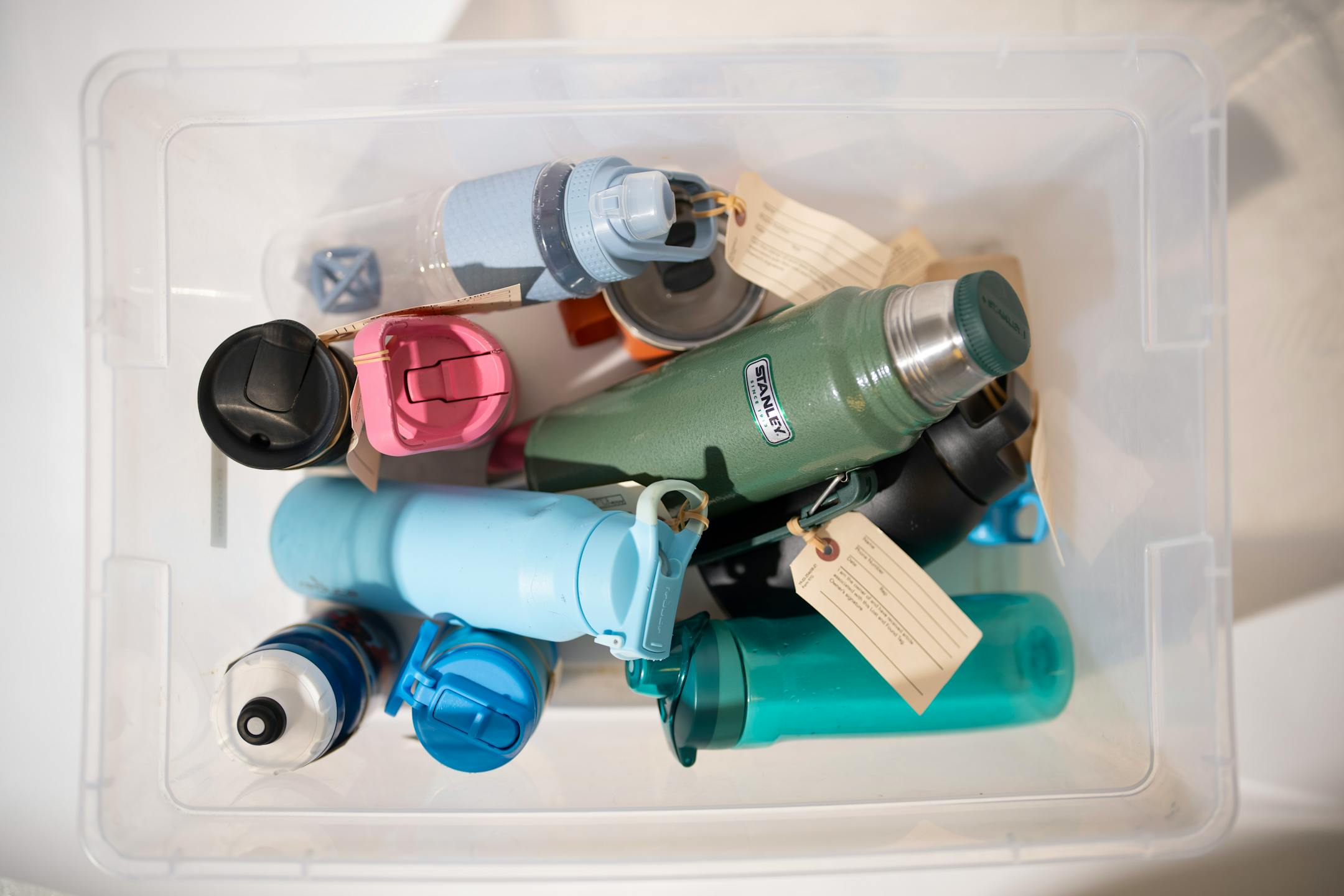 A bin of thermoses and water bottles left behind on Metro Transit vehicles recently, photographed in the Lost and Found room.