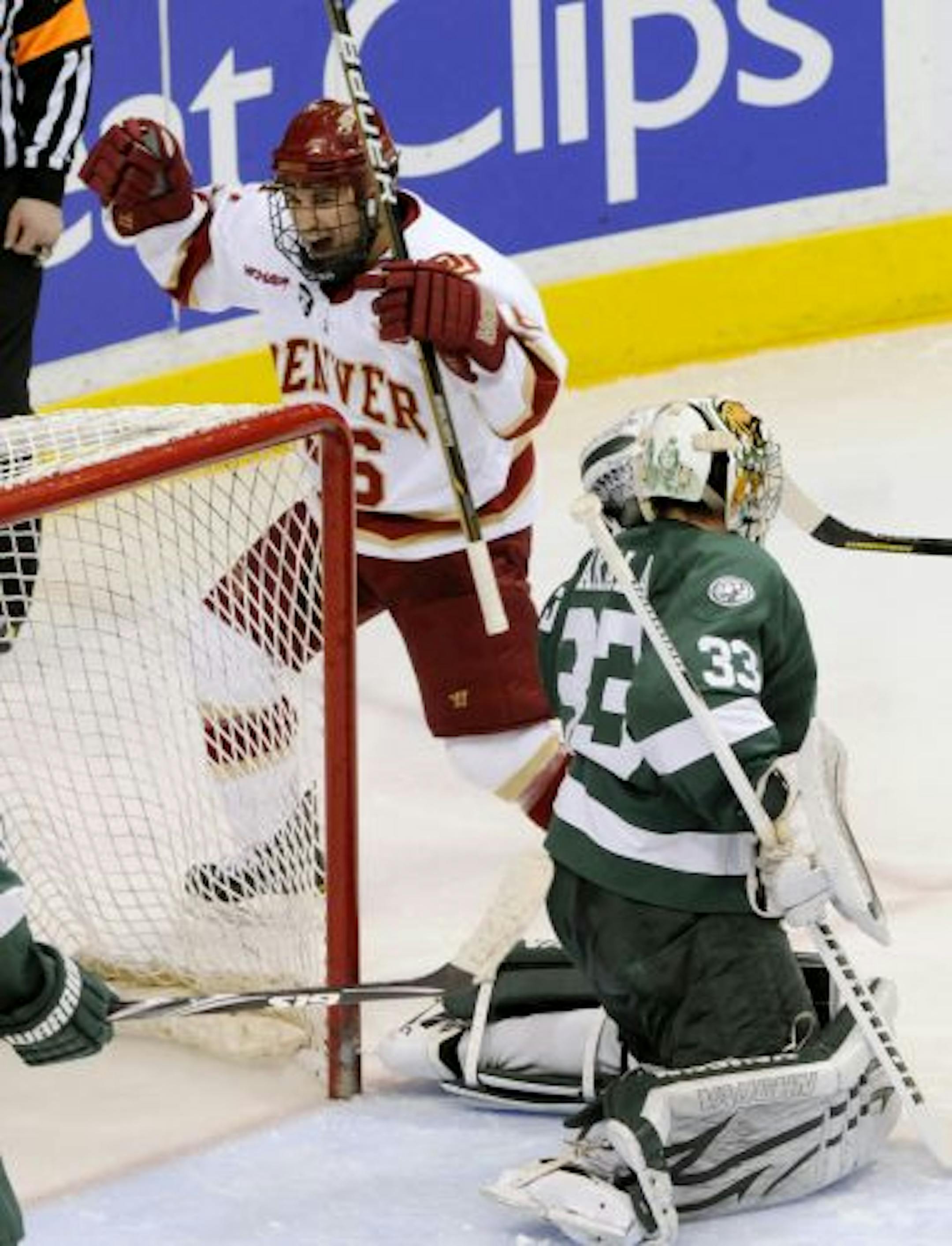 Denver's Anthony Maiani, left, celebrates a goal by Nick Shore against Bemidji State goalie Dan Bakala in the third period of a WCHA Final Five college hockey game Friday, March 18, 2011 in St. Paul, Minn. Denver won 6-2.