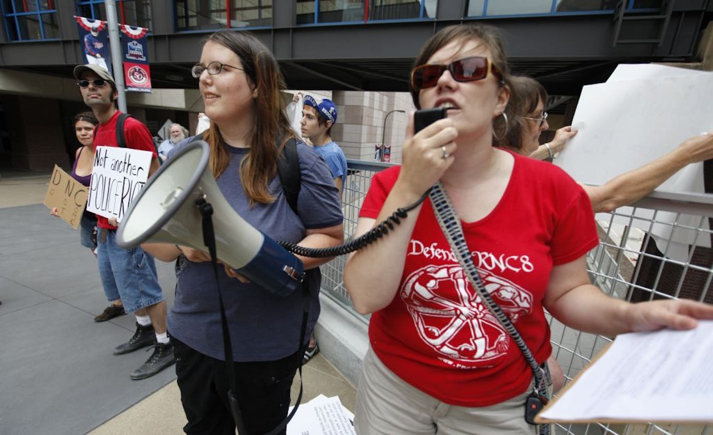 Melissa Hill, left, and Meredith Abey protested outside Target Field in July 2010, trying to rally support against bringing the Democratic National Convention to Minneapolis.