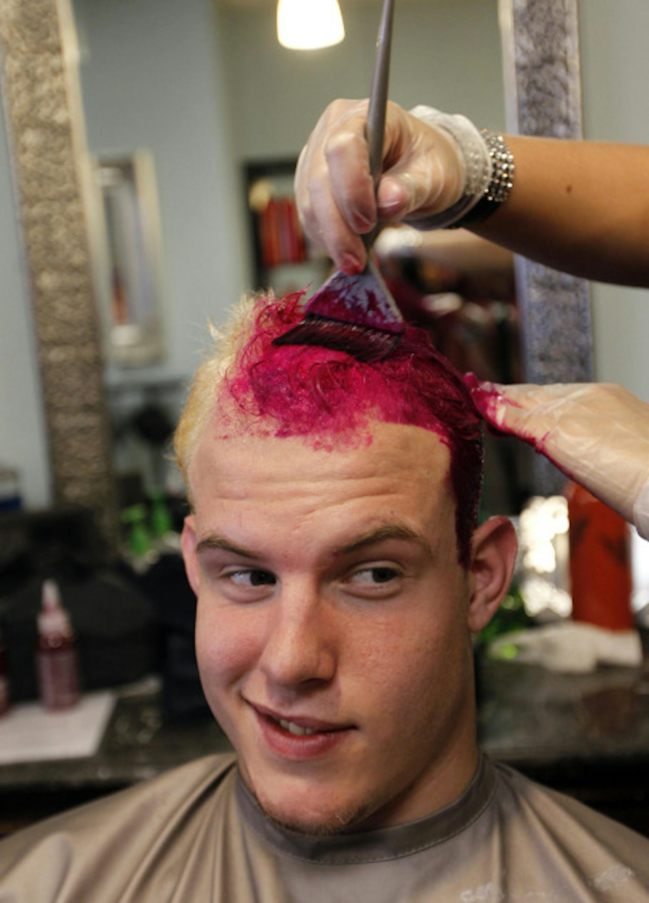 Plymouth Whalers captain James Livingston has pink dye applied at Lucky Hair Co. in Canton, Michigan, on Wednesday, October 13, 2010. The Plymouth Whalers players dyed their hair pink in support of breast cancer awareness; the Whalers play in the Ontario Hockey League. (Rashaun Rucker/Detroit Free Press/MCT)