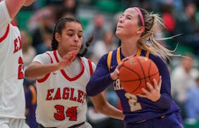 Kennedy Sanders took on Eden Prairie’s Vanessa Jordan (34) during Chaska’s victory in the Park Center Holiday Tournament. Sanders scored 22 points