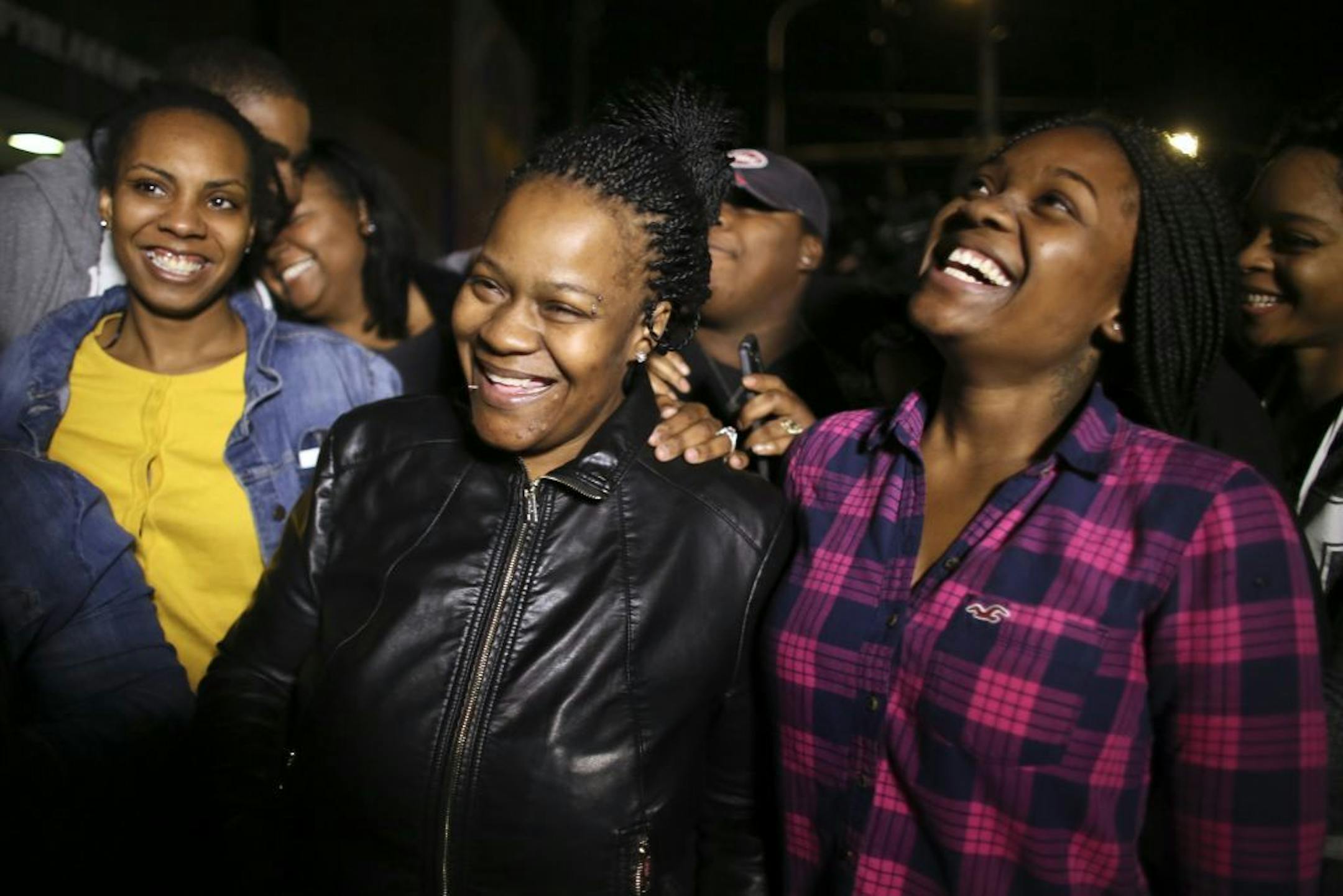 Family members surround Keisha Gaither, second from left, mother of kidnapping victim Carlesha Freeland-Gaither, as they celebrate news that she has been found alive.