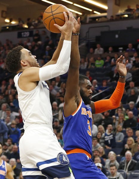 Minnesota Timberwolves' Tyus Jones, left, shoots as New York Knicks' Tim Hardaway Jr. defends in the first half of an NBA basketball game Friday, Jan.