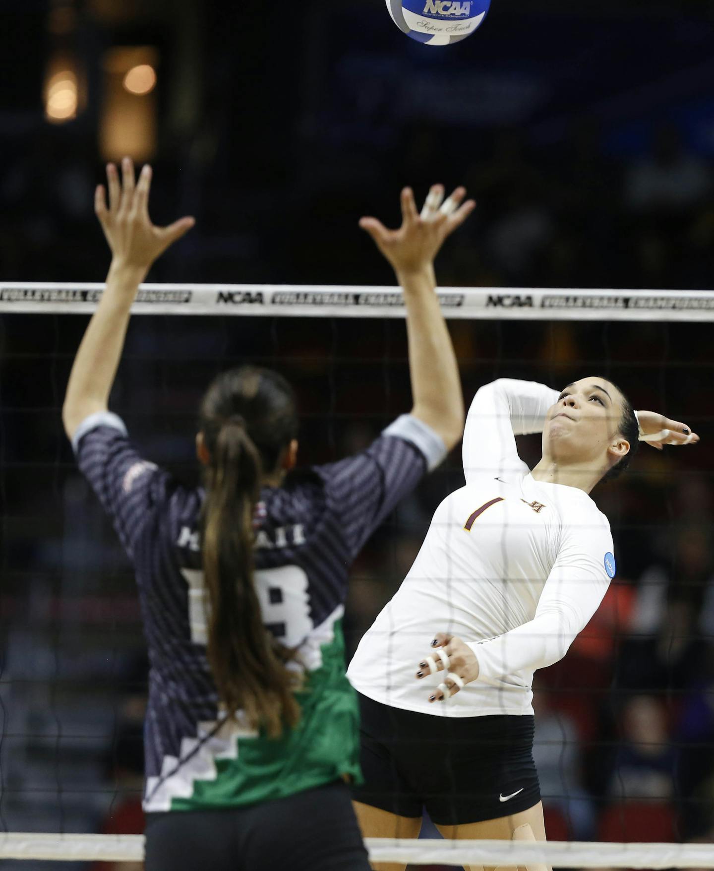 Minnesota's Daly Santana (1) spikes the ball past Hawaii's Emily Maglio (19) Saturday, Dec. 12, 2015, during the NCAA Division I Women's Volleyball Championship in Des Moines, Iowa. (The Des Moines Register, Michael Zamora/The Des Moines Register via AP)