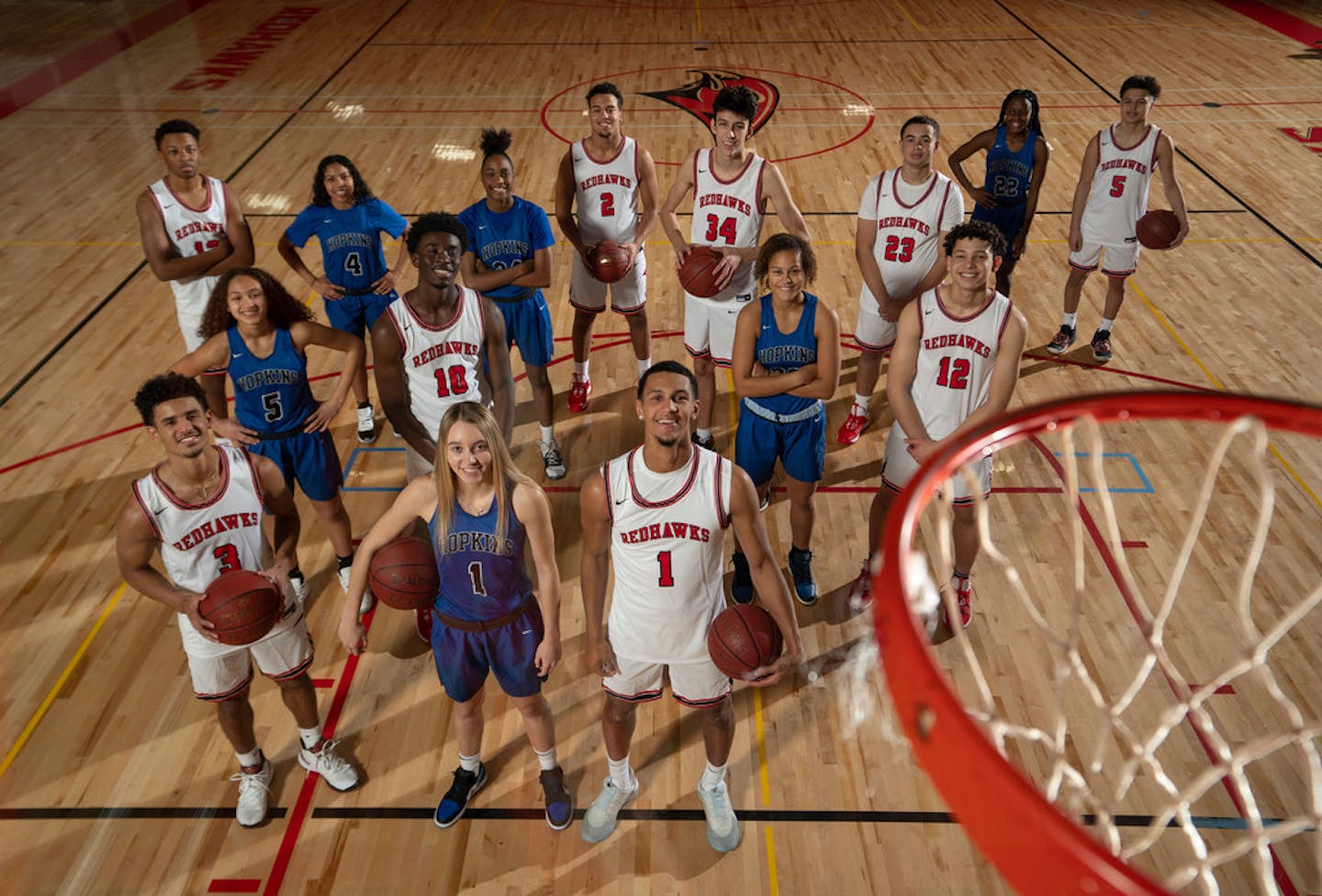 Jalen Suggs and Paige Bueckers posed with members of their teams at the start of the 2019-2020 basketball season.