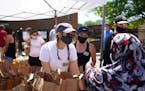 Volunteer Annika Beringer distributed bags of food and personal hygiene supplies Wednesday afternoon at Holy Trinity Lutheran Church. ] ANTHONY SOUFFL