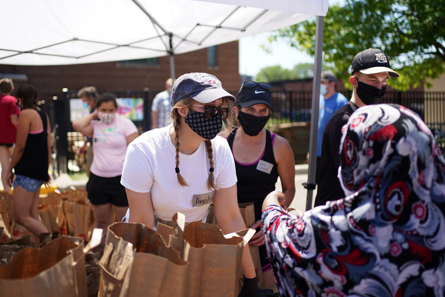 Volunteer Annika Beringer distributed bags of food and personal hygiene supplies Wednesday afternoon at Holy Trinity Lutheran Church. ] ANTHONY SOUFFLE • anthony.souffle@startribune.com Volunteers distributed food to those in need Wednesday, June 17, 2020 at Holy Trinity Lutheran Church in south Minneapolis. As the initial flood of pop up food shelves and donations have started to slow and organizations, community members and city officials are in transition mode, looking to create partnerships