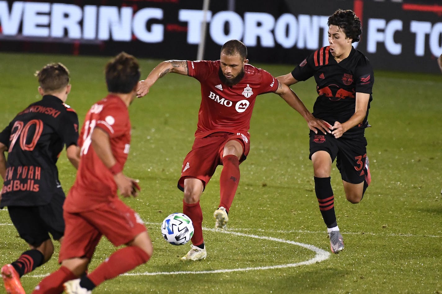 New York Red Bulls' Caden Clark, right, pressures Toronto FC's Nick DeLeon, left, during the second half of an MLS soccer match, Wednesday, Oct. 14, 2020, in East Hartford, Conn. (AP Photo/Jessica Hill) ORG XMIT: NYOTK