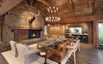 The great room's curved timbers, reclaimed barn wood and Montana granite fireplace.The lake retreat, built in 2014 in western Wisconsin, was designed 
