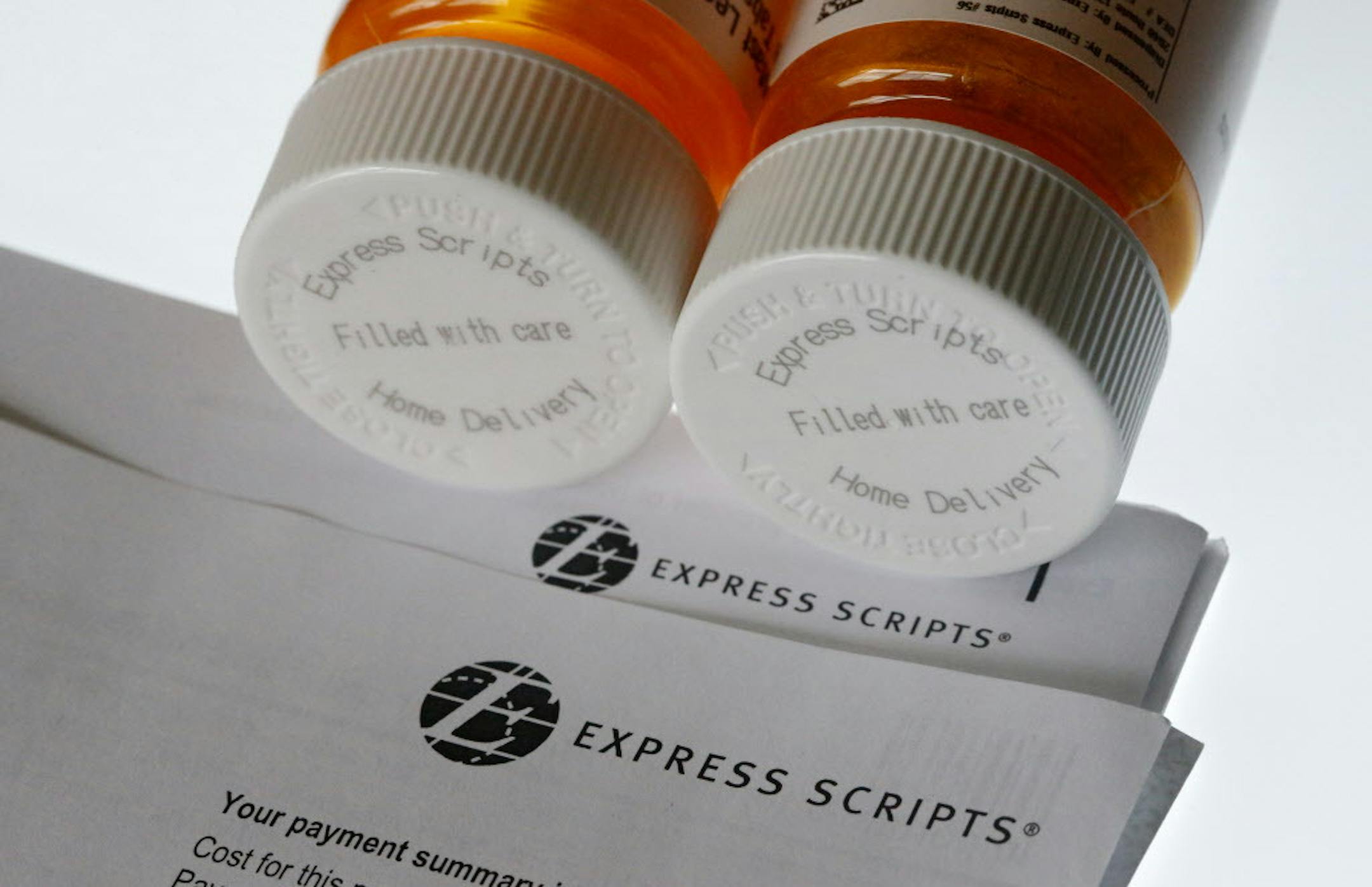 FILE - In this July 25, 2017, file photo, Express Scripts prescription medication bottles are arranged for a photo in Surfside, Fla. Health insurer Cigna will spend about $52 billion to acquire the pharmacy benefits manager Express Scripts, announced Thursday, March 8, 2018, the latest in a string of proposed buyouts and tie-ups in a rapidly shifting landscape for the health services industry. (AP Photo/Wilfredo Lee, File)